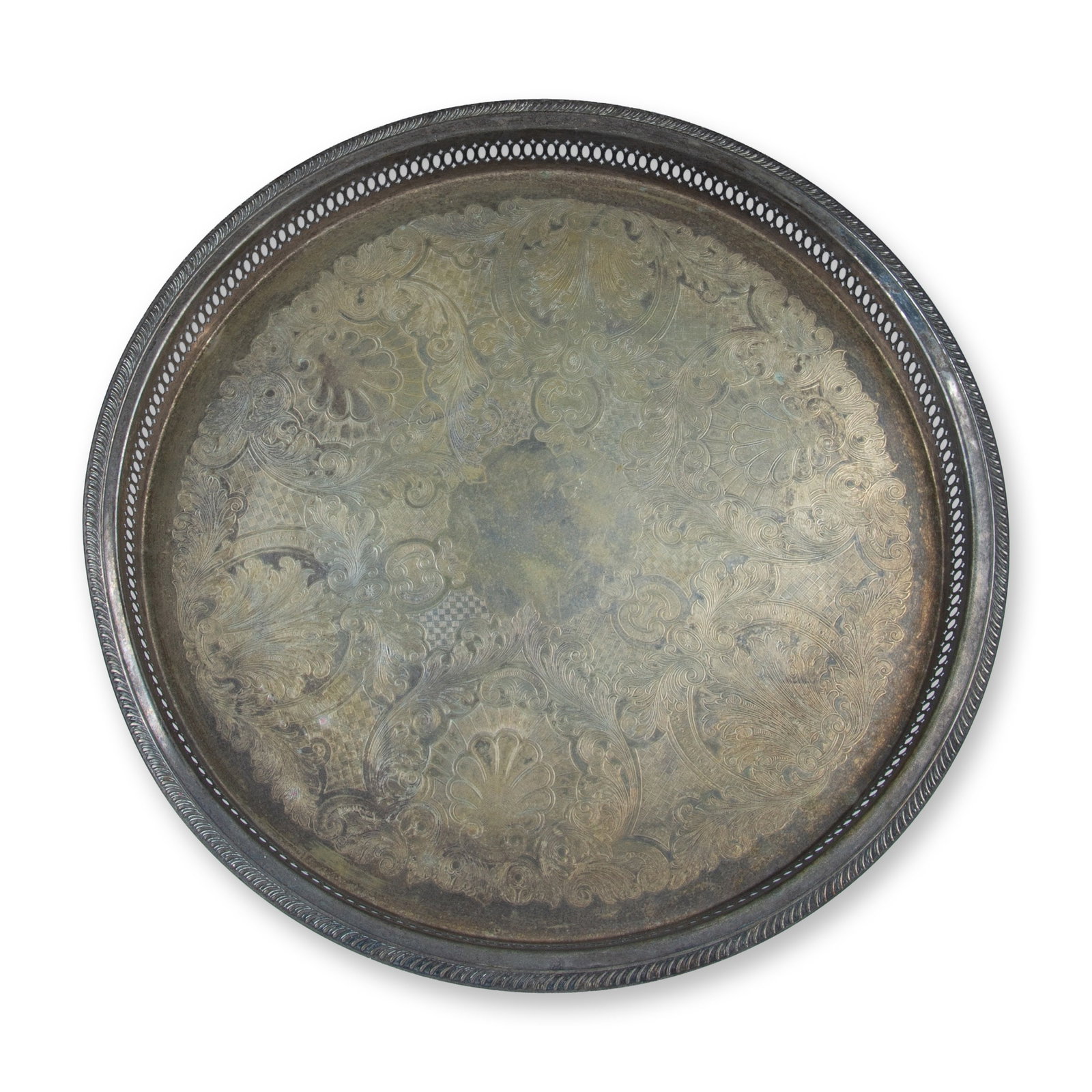 Vintage Silverplated Pierced Celtic Round Tray: A collectible highlighting Vintage Silverplated Pierced Celtic Round Tray. Metal engraved center design with filigree edge. Dimensions: 2"H x 18" dia. Date or Era: 20th century