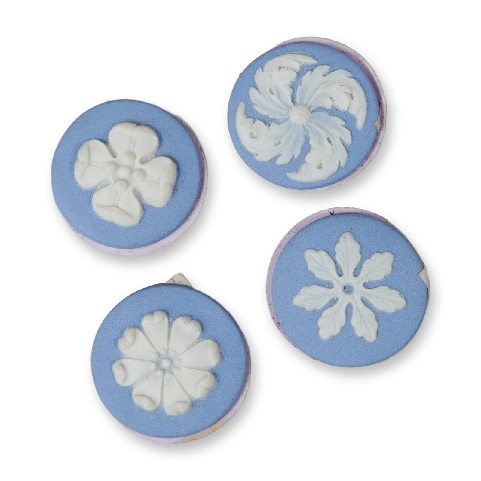 4pc Jasperware Style Ceramic Medallions with Floral Relief: A set of four small, circular medallions crafted in the style of Jasperware. Each piece features a matte, pale blue stoneware body decorated with a single applied white relief sprigged motif in the ce