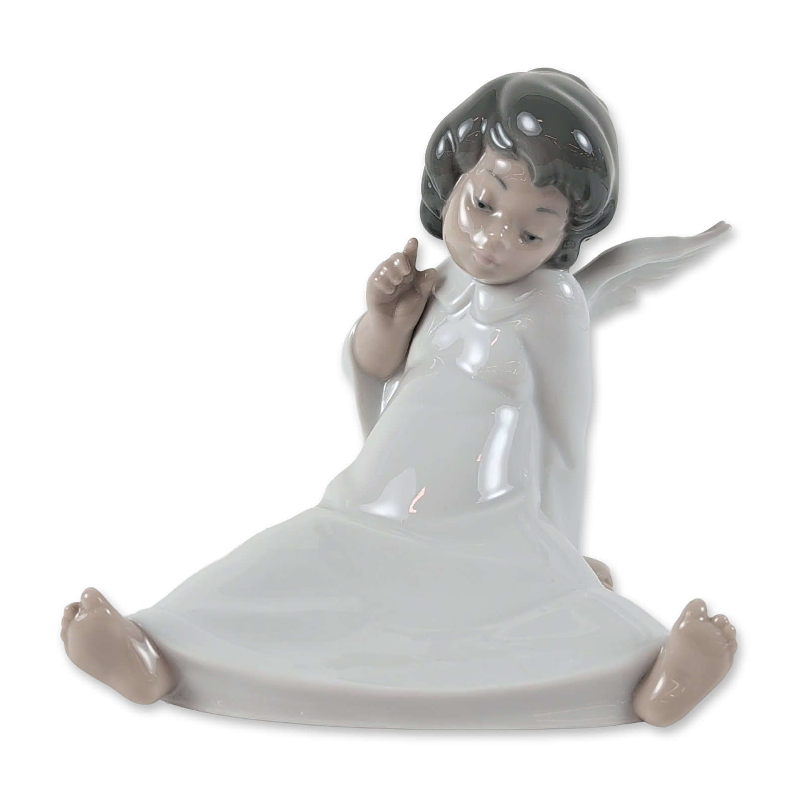 Lladro Spanish Glazed Porcelain Angel Figurine: Lladro, Spain. Glazed porcelain figurine titled Angel Wondering, model number 4962. Seated angel figure in a contemplative pose, finished in signature muted tones with a glossy white robe. Includes bl