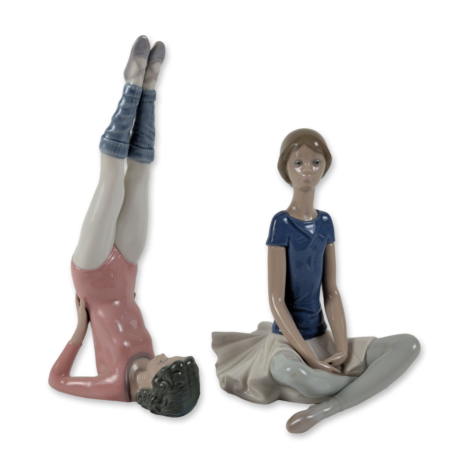 2pc Lladro Porcelain Figurines, Push Ups and Beth: Pair of glazed porcelain figurines depicting young ballerinas. The first figure titled Push Ups (1005334) is depicted wearing a pink long-sleeved leotard and blue leg warmers with legs raised up to th