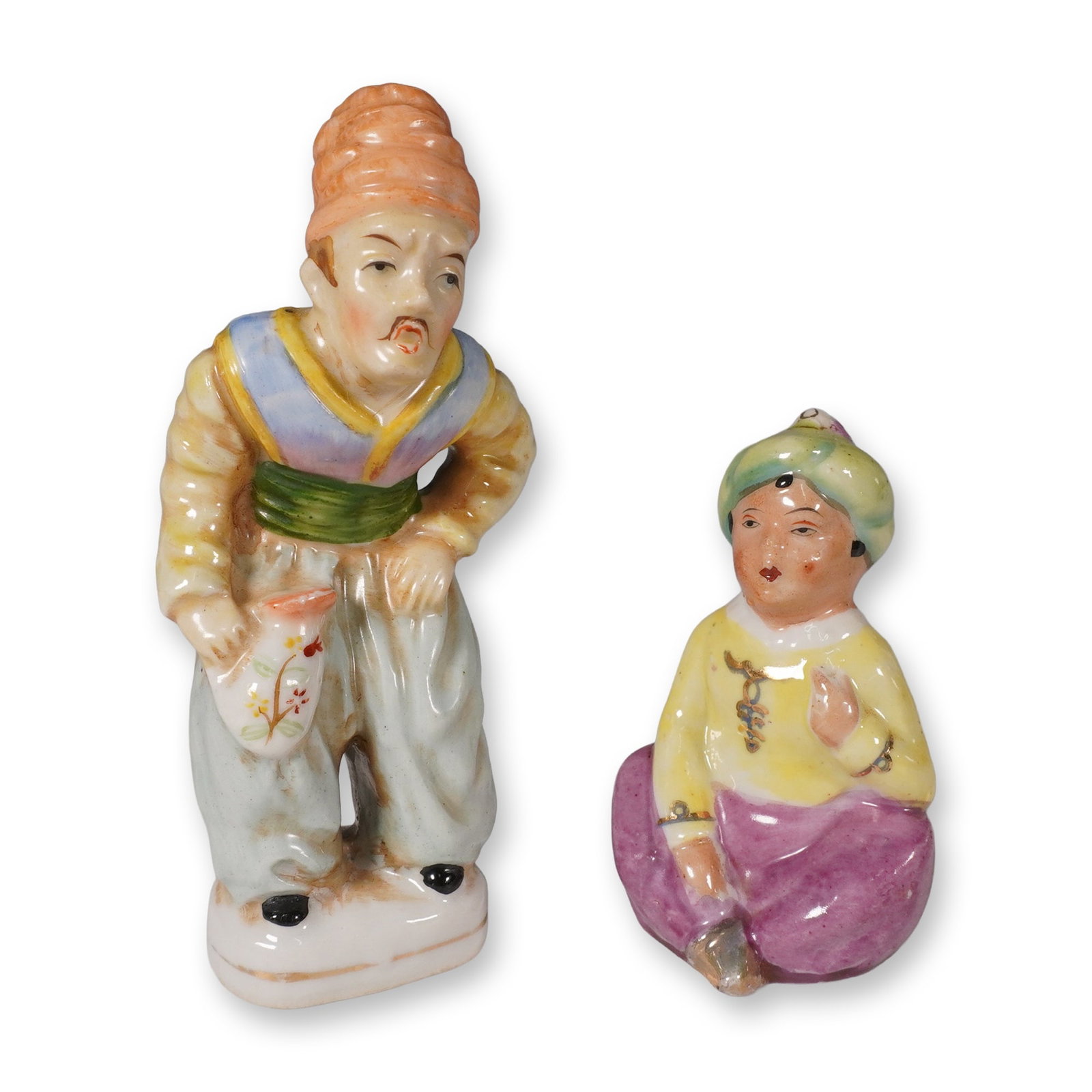 Pair of Occupied Japan Porcelain Figurines: A collectible highlighting Pair of Occupied Japan Porcelain Figurines. Two vintage Occupied Japan porcelain figurines (1945-1952), each finely hand-painted with vibrant colors portraying Eastern-inspi