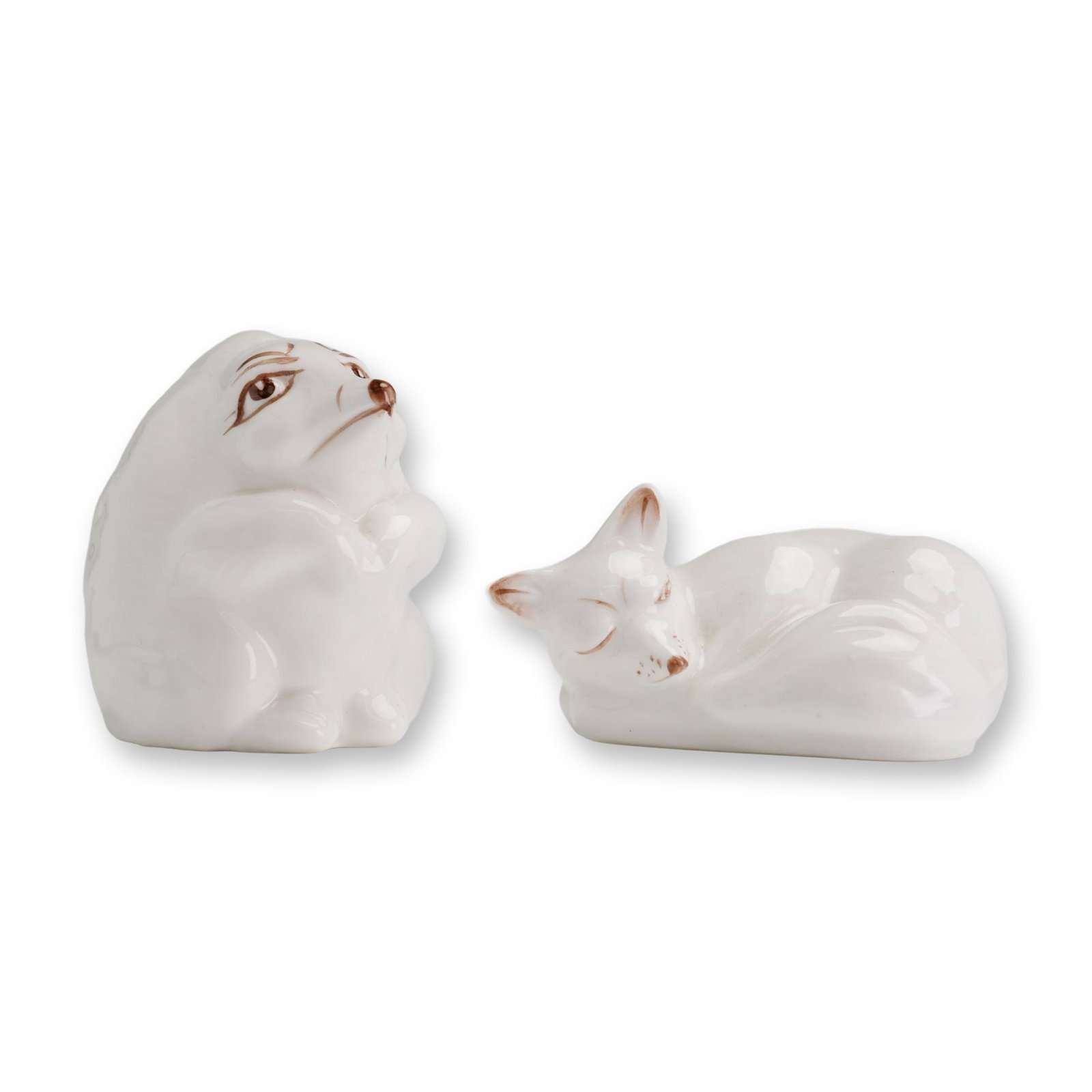 2pc Coalport English Bone China Hedgehog and Fox Figurine: Coalport, England. Pair of stylized animal figurines in glazed white bone china, including one attentive upright hedgehog and one sleeping curled fox. Each piece features minimalist hand-painted brown