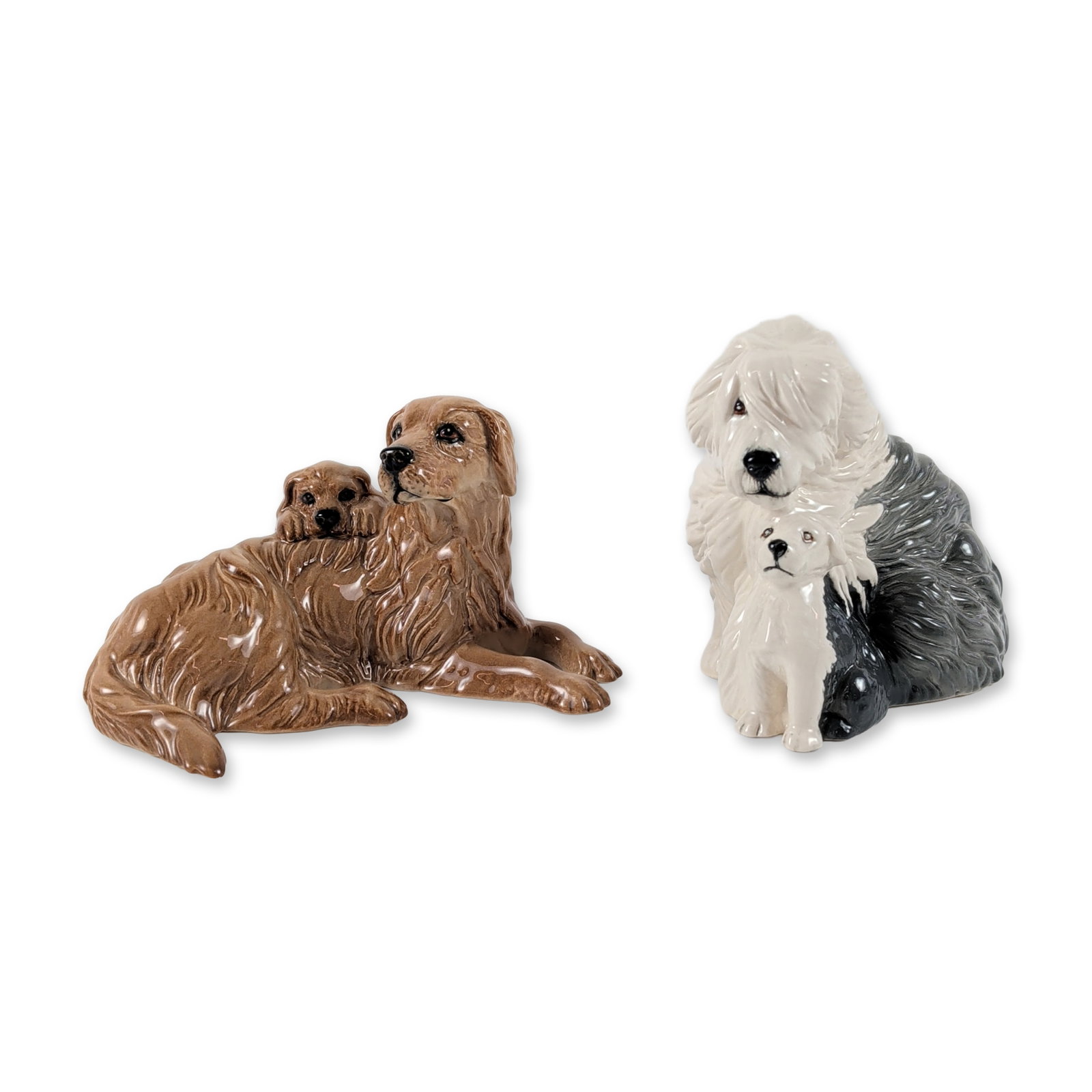 2pc Royal Doulton Ceramic Mother and Puppy Dog Figurines: Royal Doulton, England. Two figurines in high-gloss glazed ceramic, each depicting a mother dog reclining with her puppy. The lot includes one Old English Sheepdog in a gray and white colorway and one