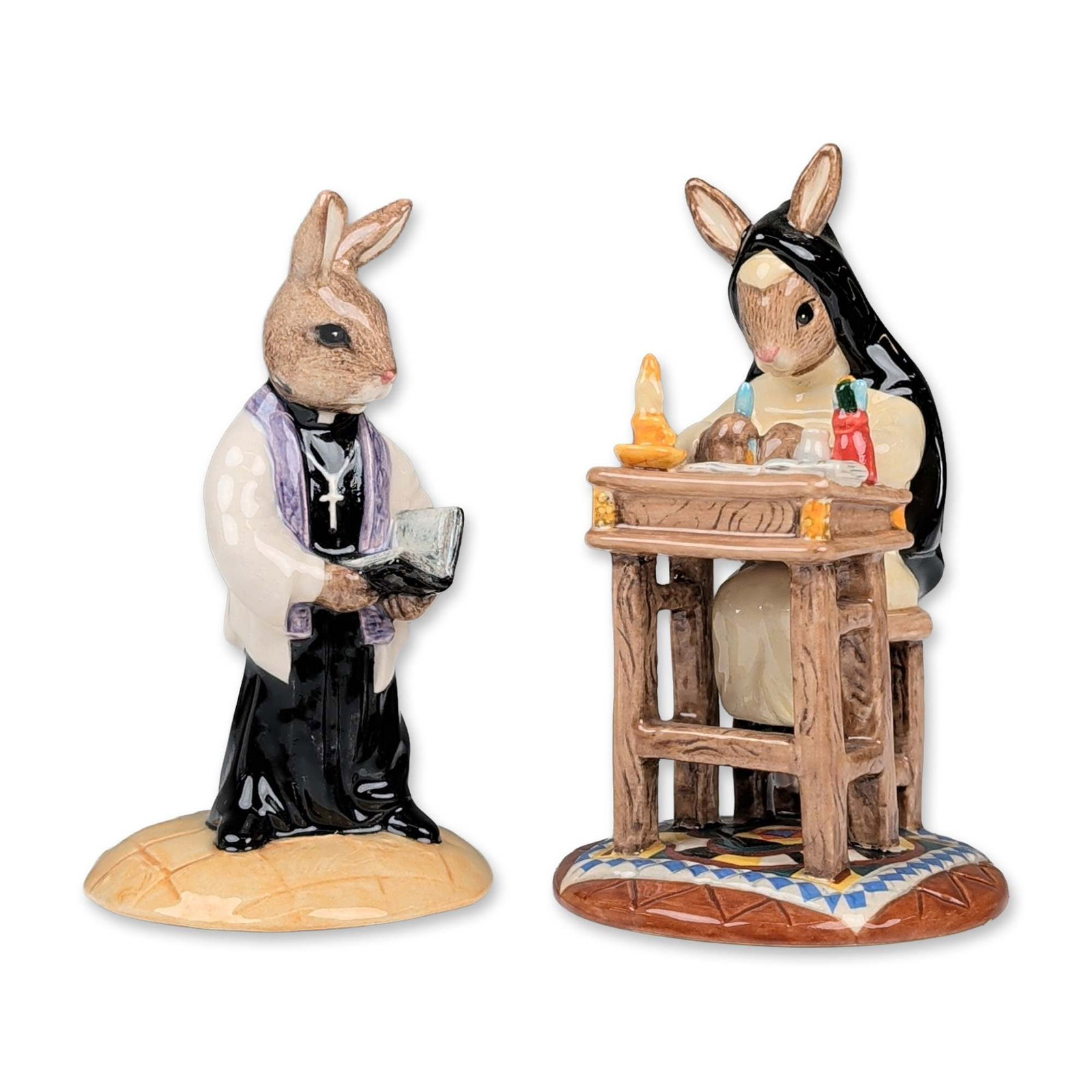 Pair of Royal Doulton Bunnykins Ecclesiastical Figurines: Royal Doulton. Pair of Bunnykins figurines in hand-decorated glazed ceramic, featuring rabbit characters in ecclesiastical attire. The lot includes "Sister Mary Barbara Bunnykins" (DB 334), depicted a