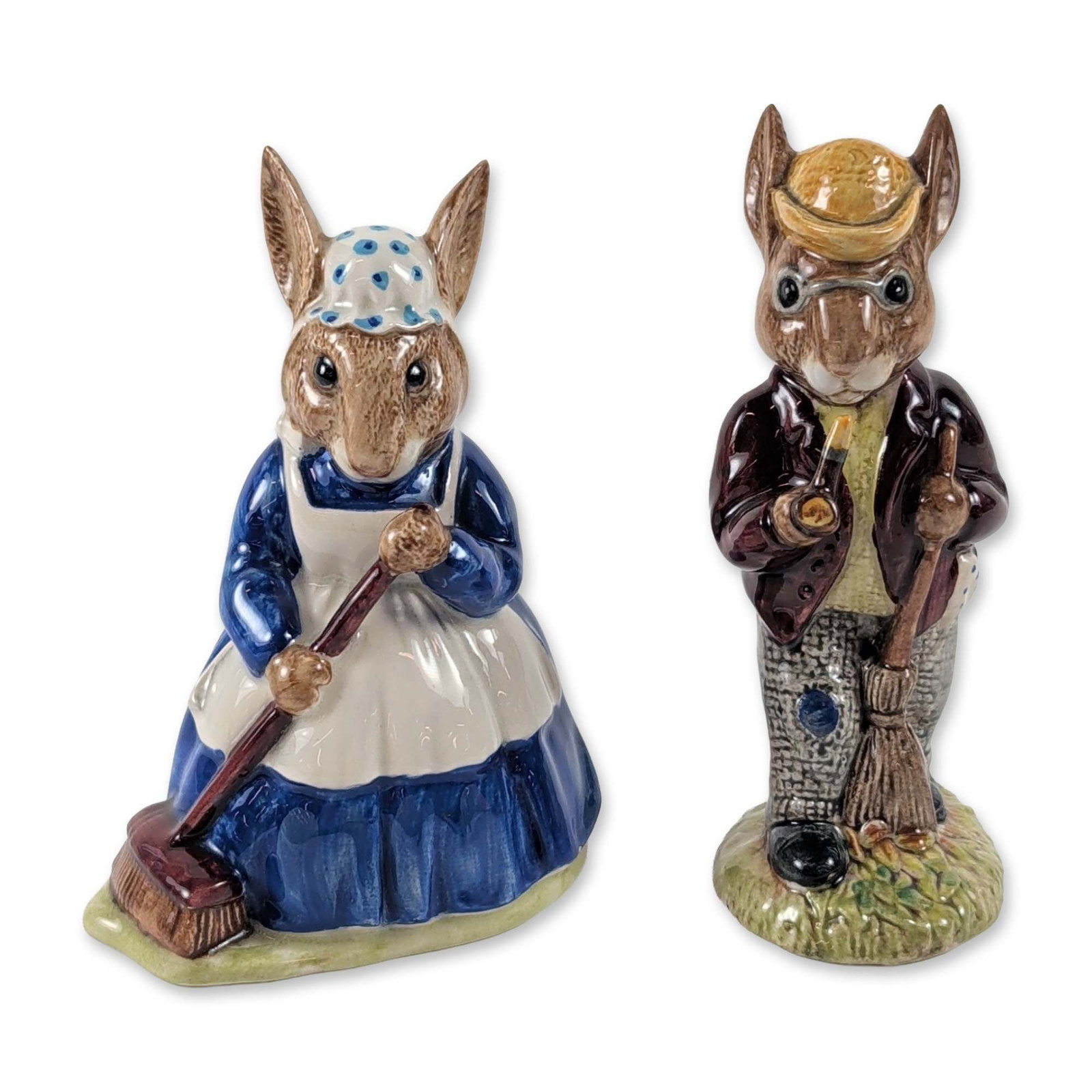 2pc Royal Doulton Bunnykins Ceramic Figurines: Royal Doulton pair of Bunnykins figurines in glazed ceramic, modeled as rabbits in occupational attire. The first figure, titled Mr. Bunnykins - Autumn Days (DB 5), depicts a rabbit holding a broom an