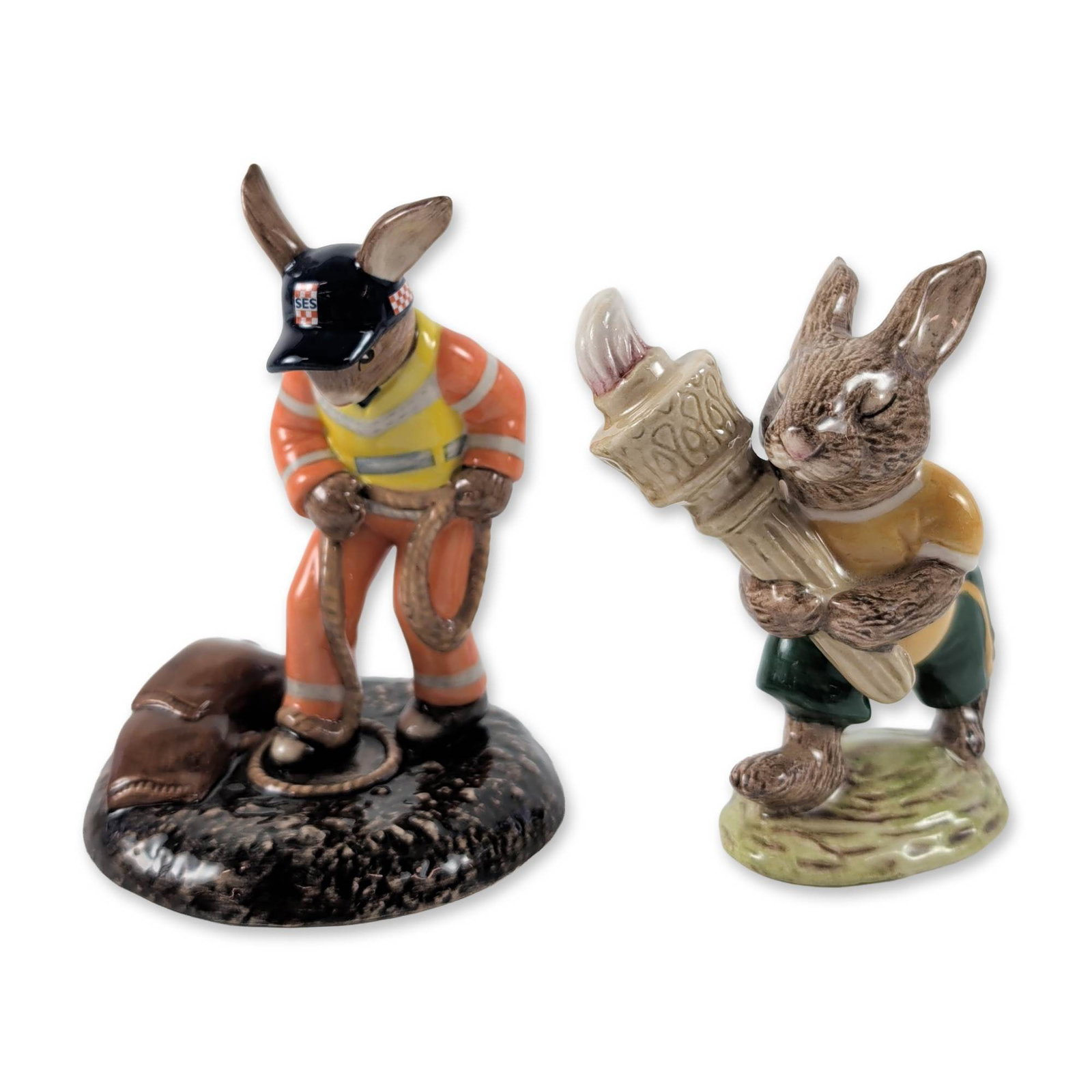 2pc Royal Doulton Bunnykins Figurines: 2pc Royal Doulton Bunnykins hand-decorated earthenware figurines. The first is the Olympic Bunnykins (DB 28) model, issued in 1983 to commemorate the Golden Jubilee Celebration of the series. The figu