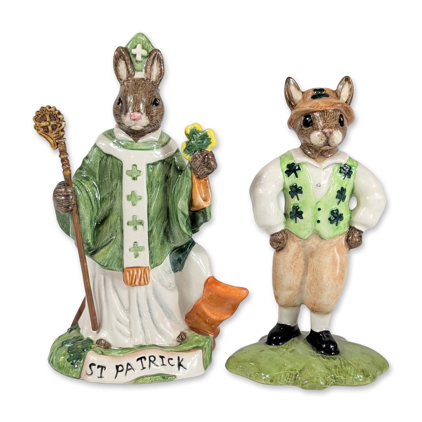 2pc Royal Doulton Bunnykins Irish Ceramic Figurines: Royal Doulton. Two hand-painted glazed ceramic figurines from the Bunnykins series, including "Irishman" (DB 178) and "St. Patrick" (DB 397). The "Irishman" rabbit is depicted in a shamrock-patterned 