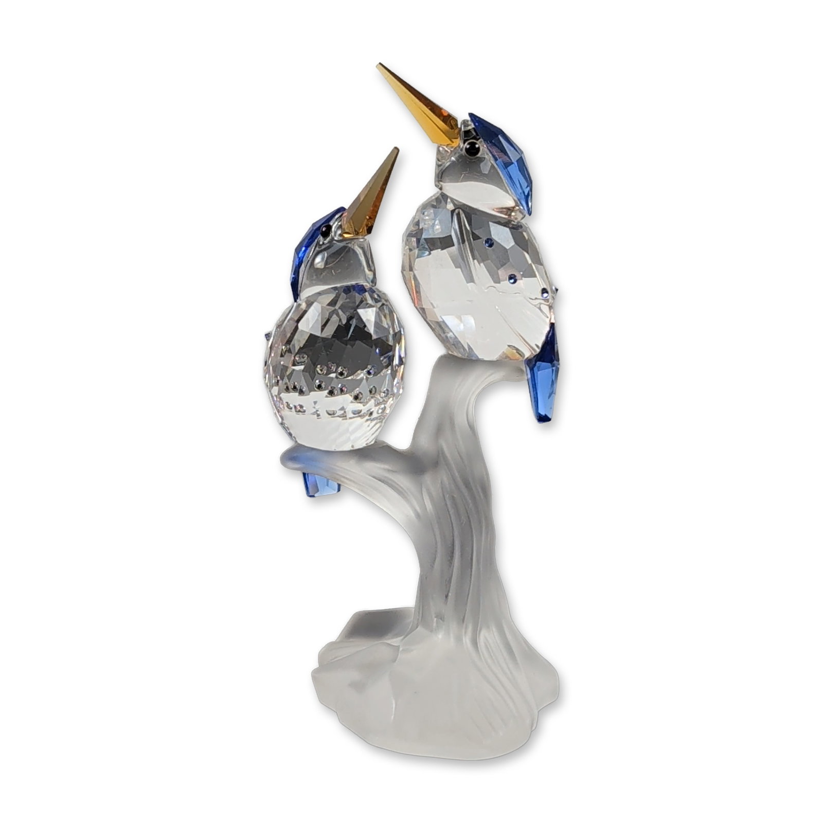 Swarovski Crystal Malachite Kingfishers Figurine: Swarovski. Figurine in faceted and frosted lead crystal depicting two kingfishers perched on a branch. The birds feature clear faceted crystal bodies, sapphire blue accents on the heads and tails, amb