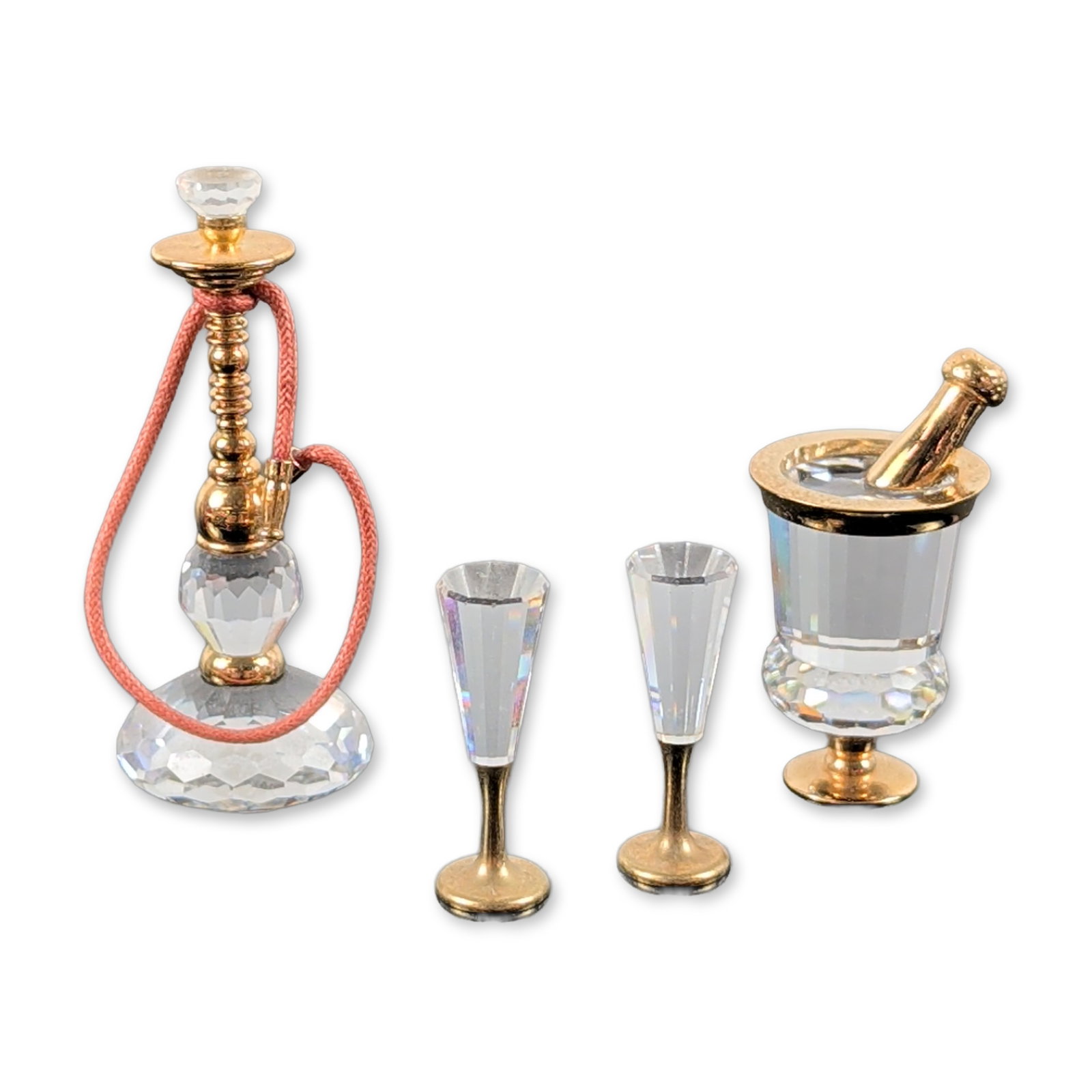 2pc Swarovski Crystal Memories Figurines: Swarovski. Two faceted clear lead crystal figurines from the Crystal Memories series with gold-plated metal accents. The first is a champagne set featuring a faceted bucket containing a bottle and two