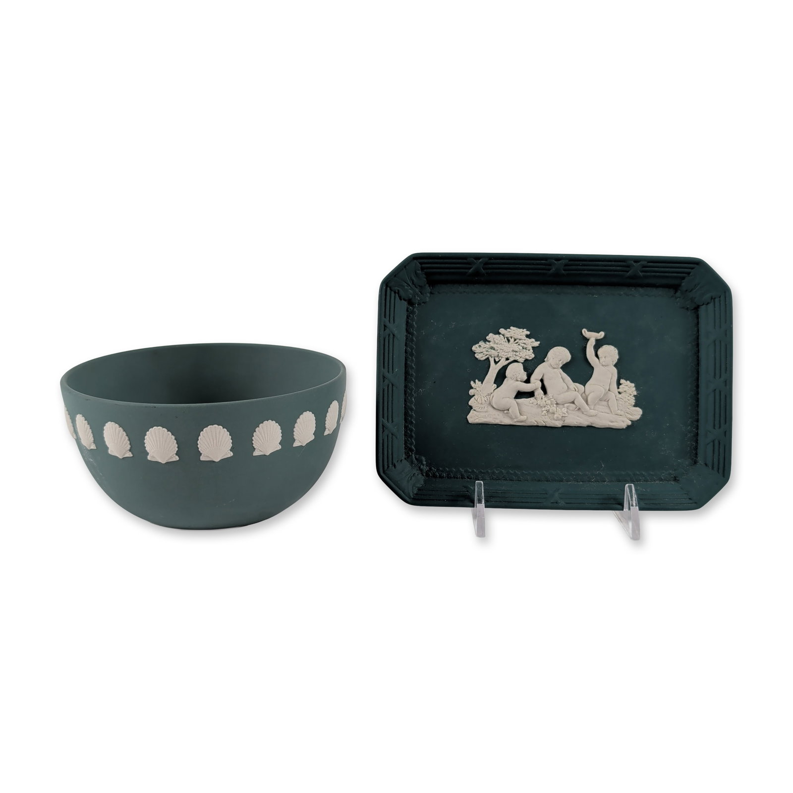 Two Wedgwood Jasperware Green Ceramic Table Wares: Wedgwood. Rectangular tray and small commemorative bowl in Jasperware stoneware. The rectangular tray features a dark spruce green ground with applied white bas-relief depicting cherubs playing in a l