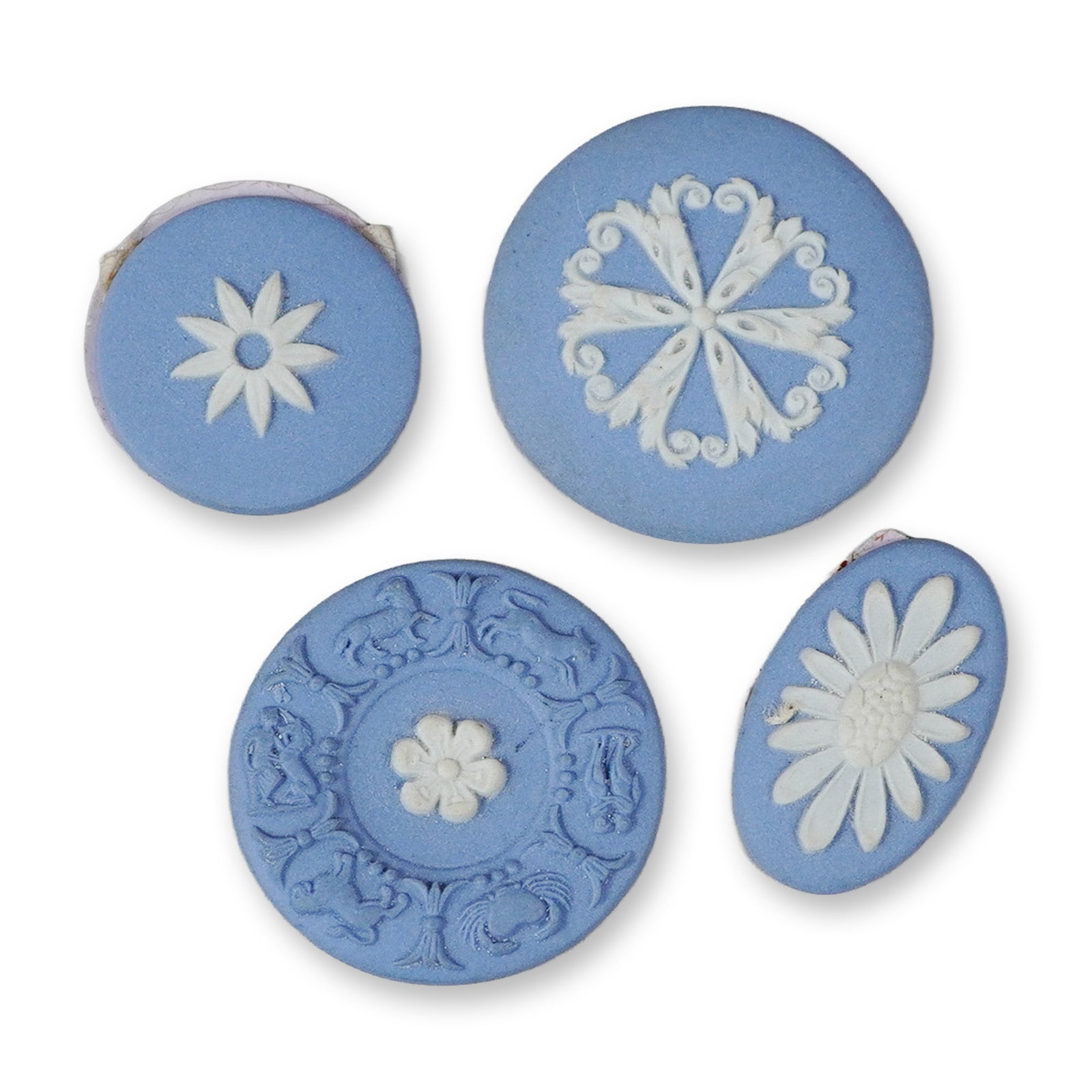 4pc Jasperware Style Decorative Plaques: This lot consists of four small decorative plaques or buttons crafted in the style of Wedgwood jasperware. Each piece is composed of matte-finished, unglazed light blue stoneware with applied white ba