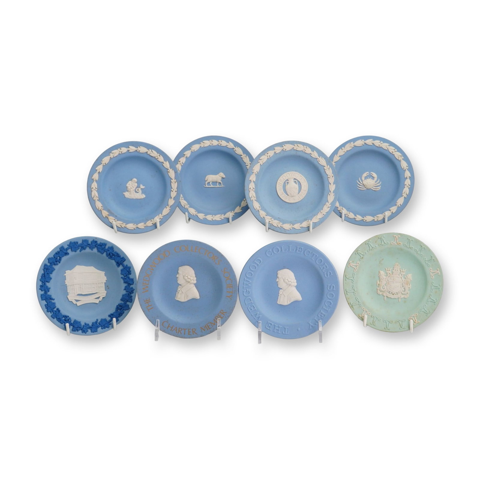 8pc Wedgwood Jasperware Commemorative Small Plates: Wedgwood, English, late 20th century. Set of eight small jasperware collector plates in stoneware with applied white bas-relief sprigged decoration. The collection includes seven examples in tradition