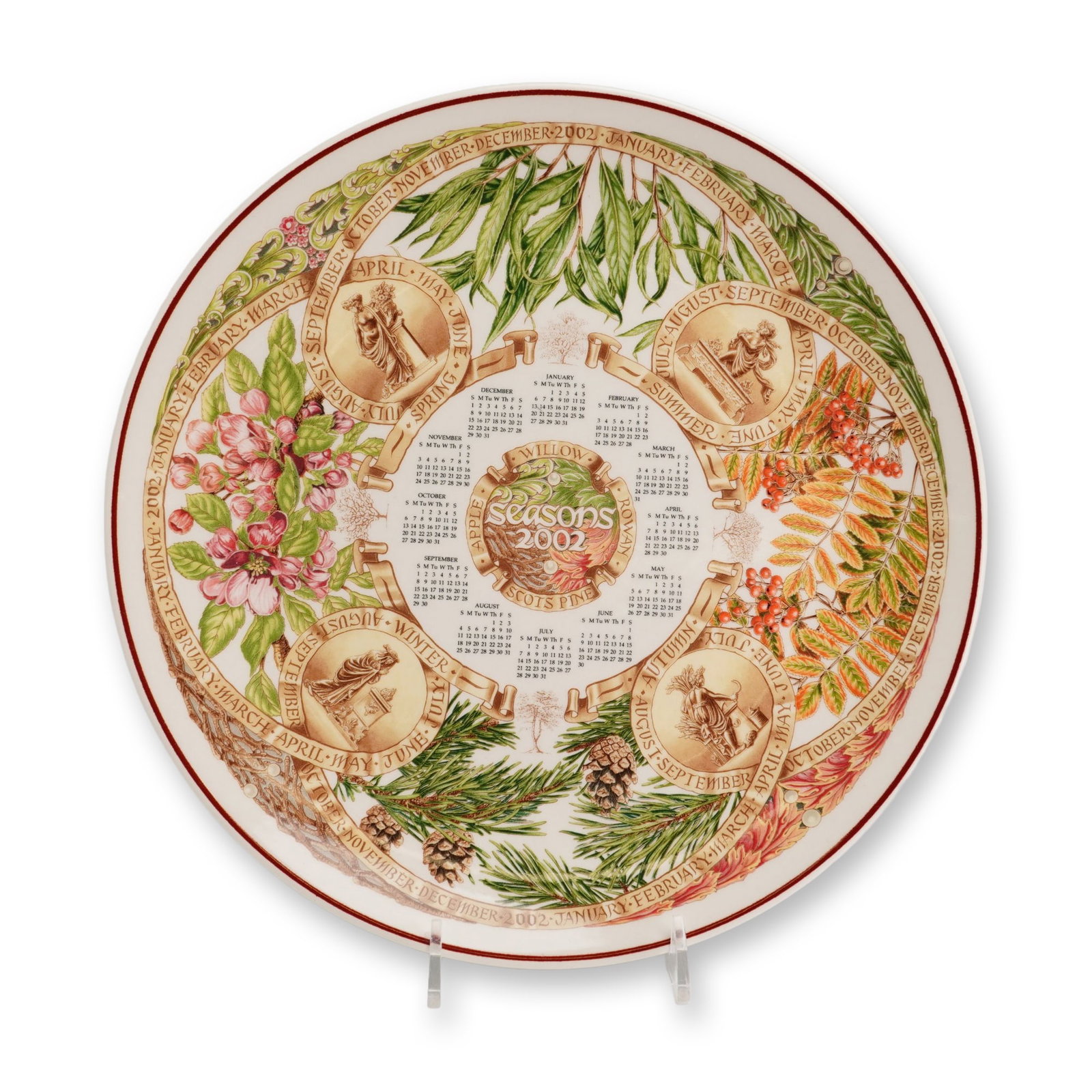 Wedgwood 2002 Seasons Trees Calendar Plate: A Wedgwood Queen's Ware refined earthenware calendar plate for the year 2002, titled Trees as part of the Seasons series. The face features a multicolor transfer-printed design with twelve monthly cal
