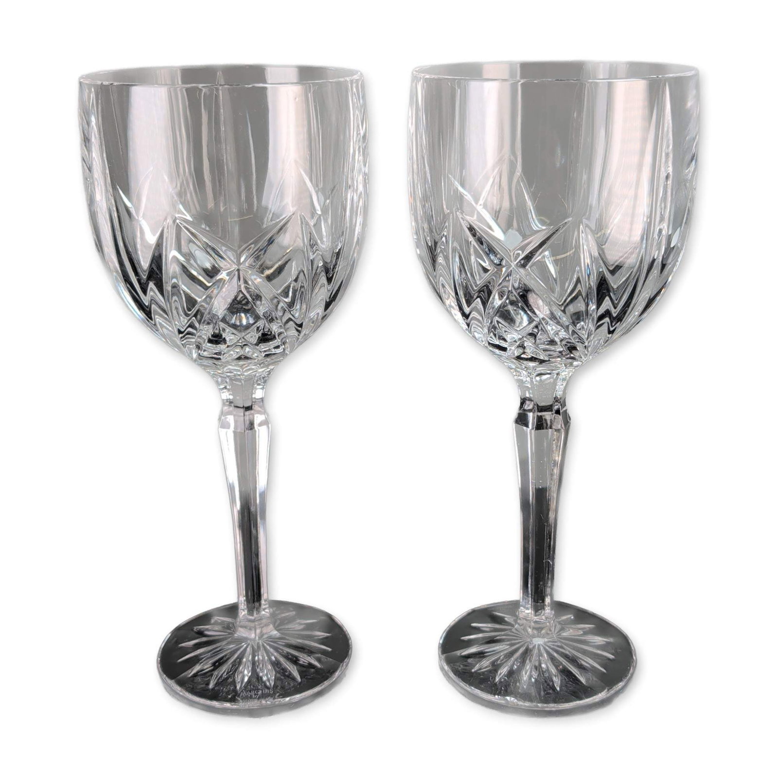 Pair of Marquis by Waterford Brookside Wine Goblets: Marquis by Waterford. Pair of wine goblets in the Brookside pattern, crafted in cut crystal. The design features vertical linear cuts on the upper bowl transitioning into a geometric diamond and wedge