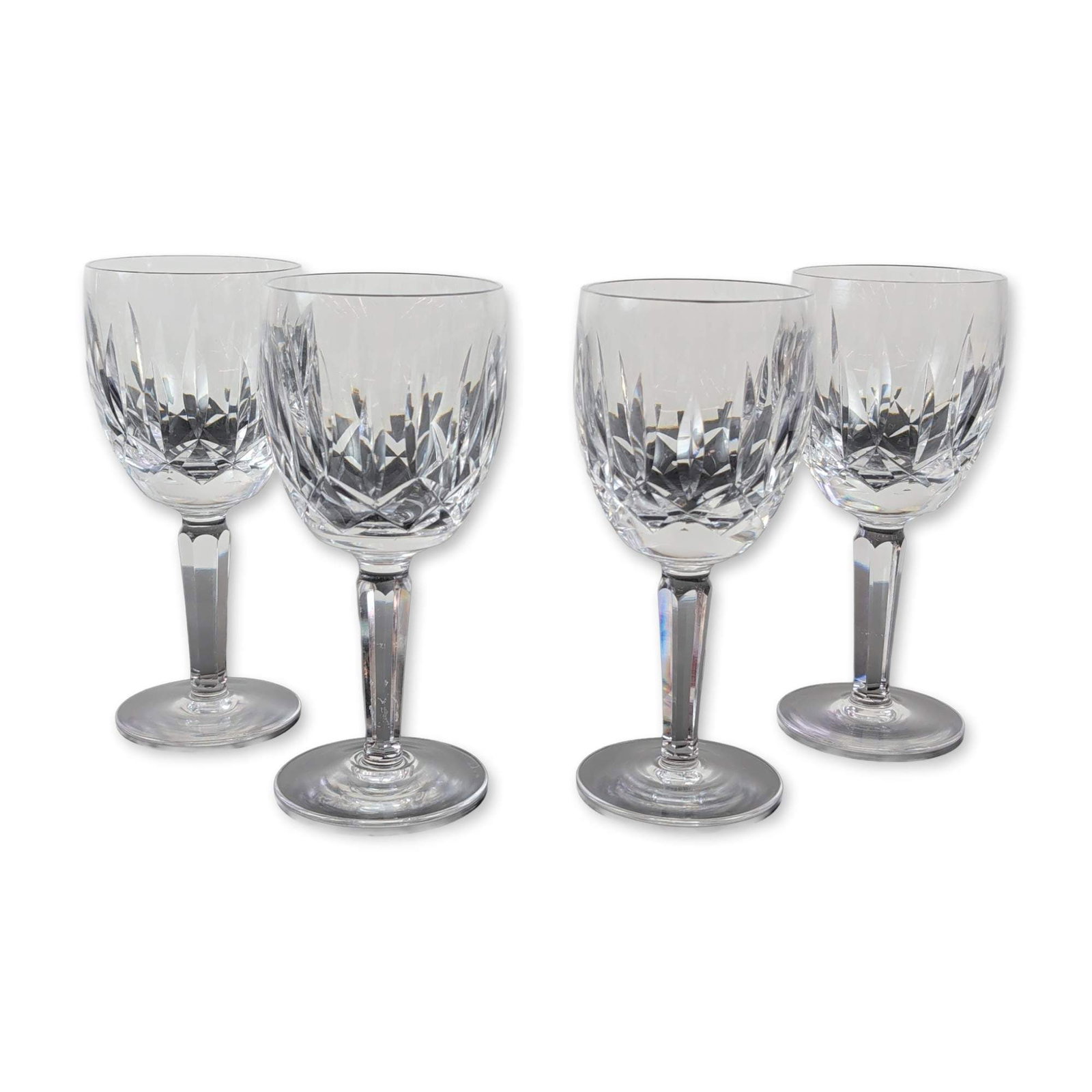 4pc Waterford Kildare Wine Glasses: Waterford Crystal, Ireland. Group of four wine glasses in the Kildare pattern, crafted from lead crystal. Each bowl features characteristic vertical wedge cuts over a central band of diamond-cut cross