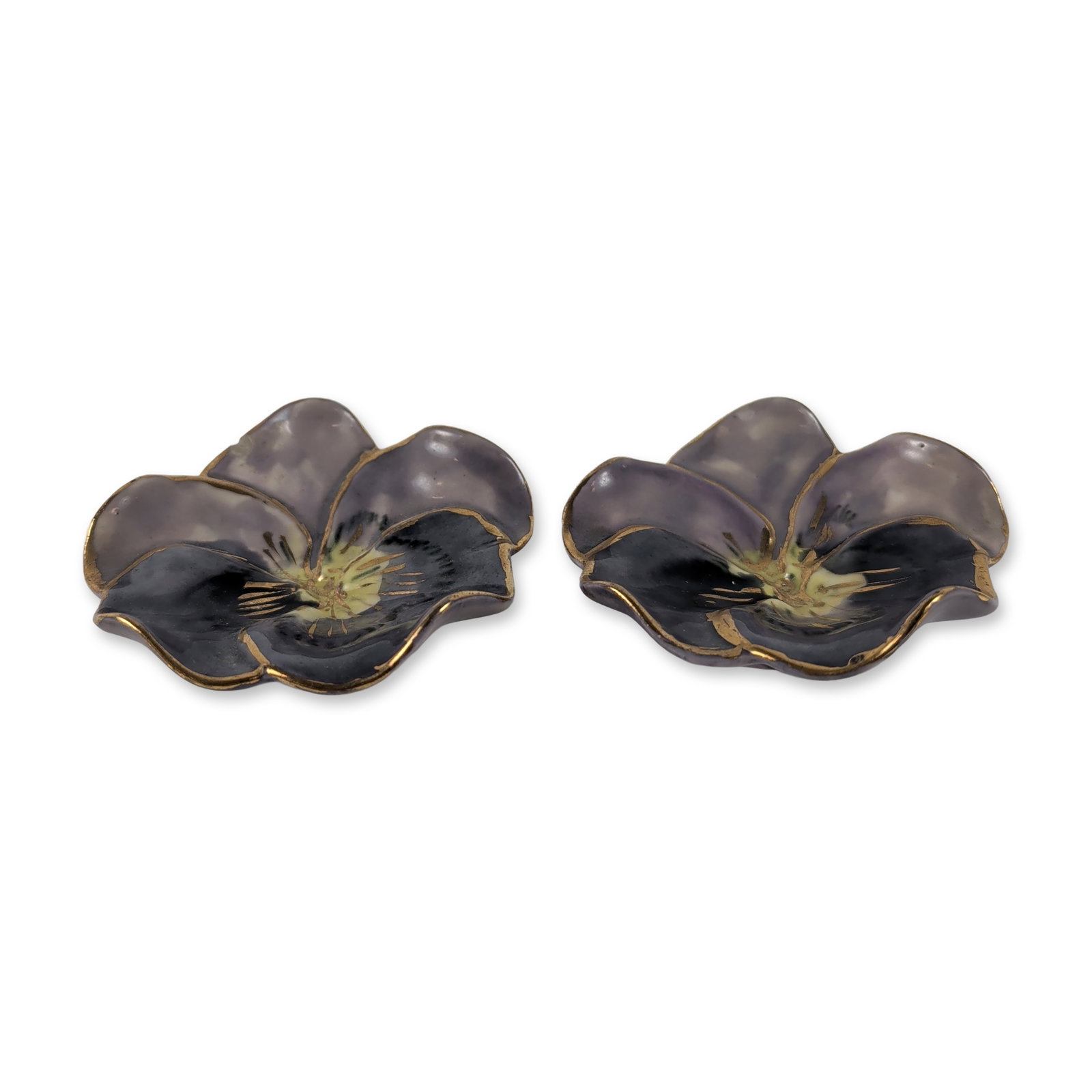2pc RC Marked Ceramic Pansy Dishes: Small hand-painted ceramic dishes modeled as pansy flowers. Each piece features petals in variegated shades of lavender and charcoal-purple glaze, accented with yellow and dark brown details at the ce