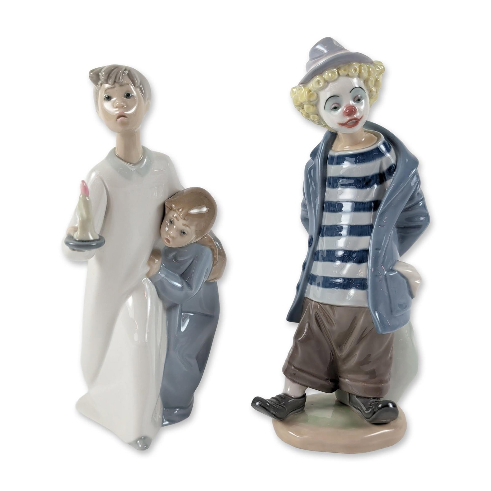 2pc Lladro Porcelain Figurines, Boy and Girl and Little Traveler: Two polychrome glazed porcelain figurines including Boy and Girl (1004874) and Little Traveler (1007602). Boy and Girl depicts a boy in a white nightgown holding a candle with a girl under his arm. Li
