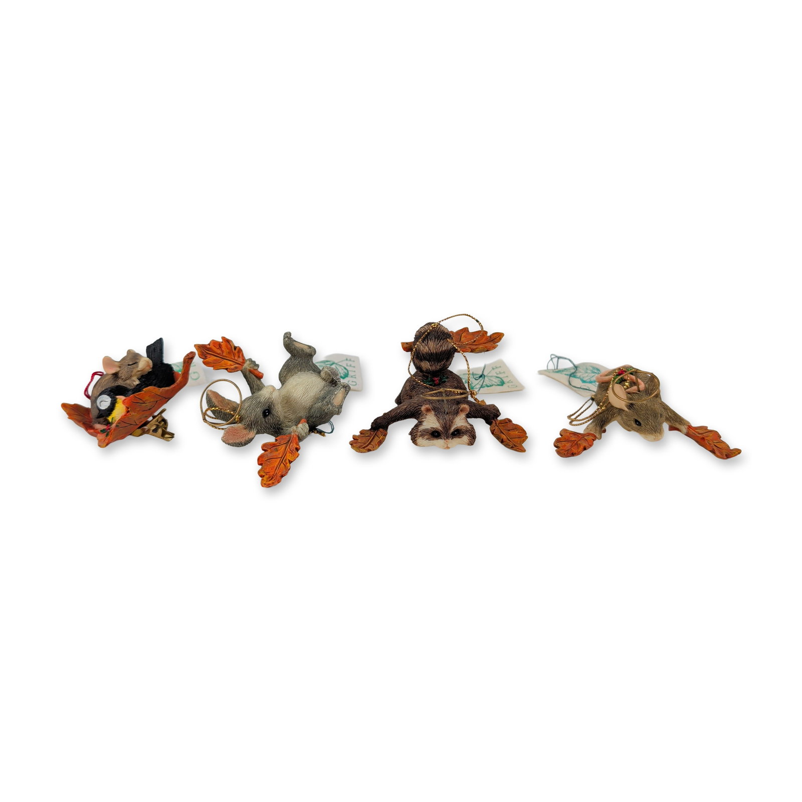 4pc Charming Tails Dean Griff Ornaments: Charming Tails collection designed by Dean Griff. Group of four autumn-themed ornaments in hand-painted cast resin, featuring woodland animals with orange oak leaves and gold-tone wire halos. The figu