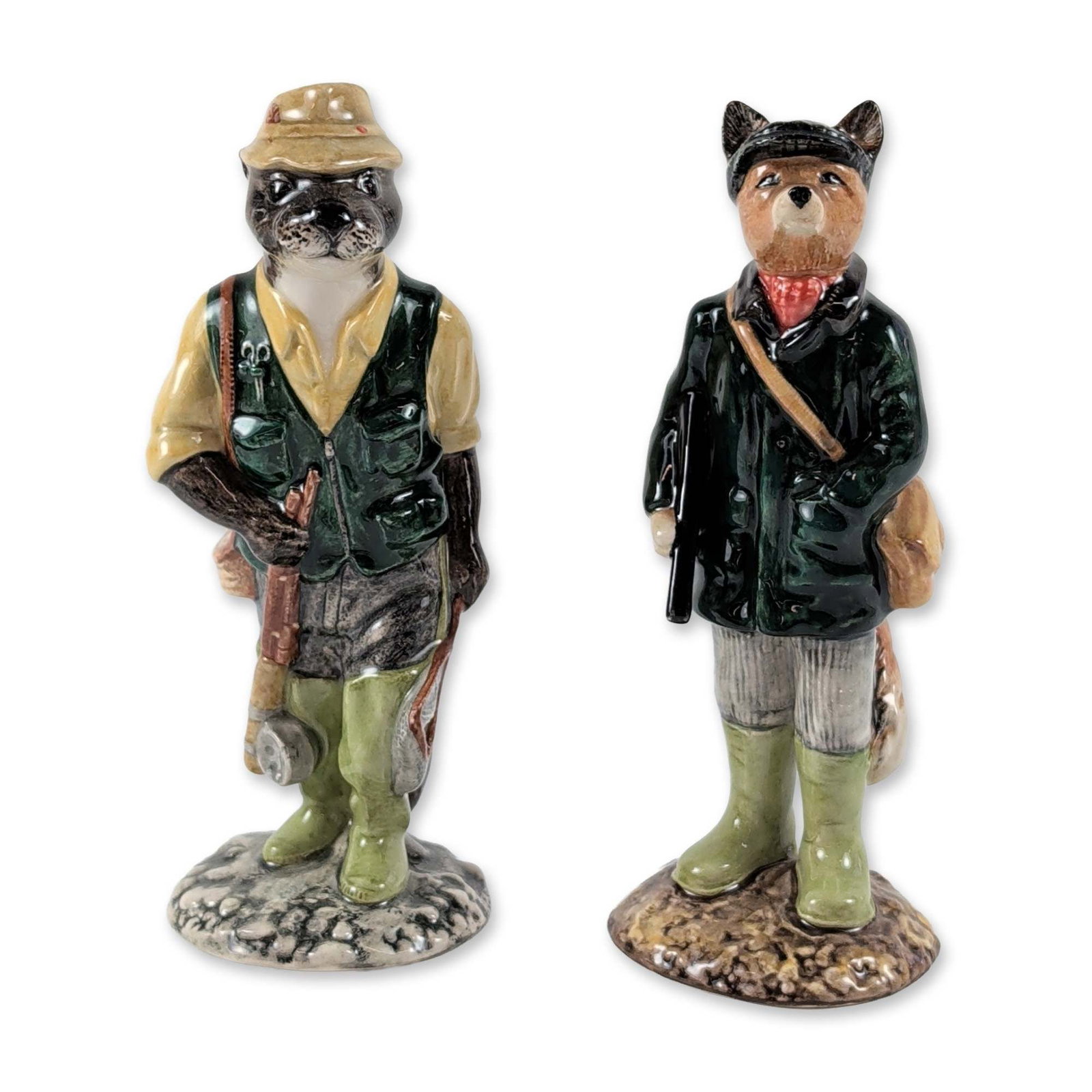 2pc Beswick English Country Folk Ceramic Figurines: Beswick, England glazed ceramic figurines from the English Country Folk series, comprising Huntsman Fox (ECF1) and Fisherman Otter (ECF 2). Huntsman Fox is modeled wearing a sporting green coat, red c