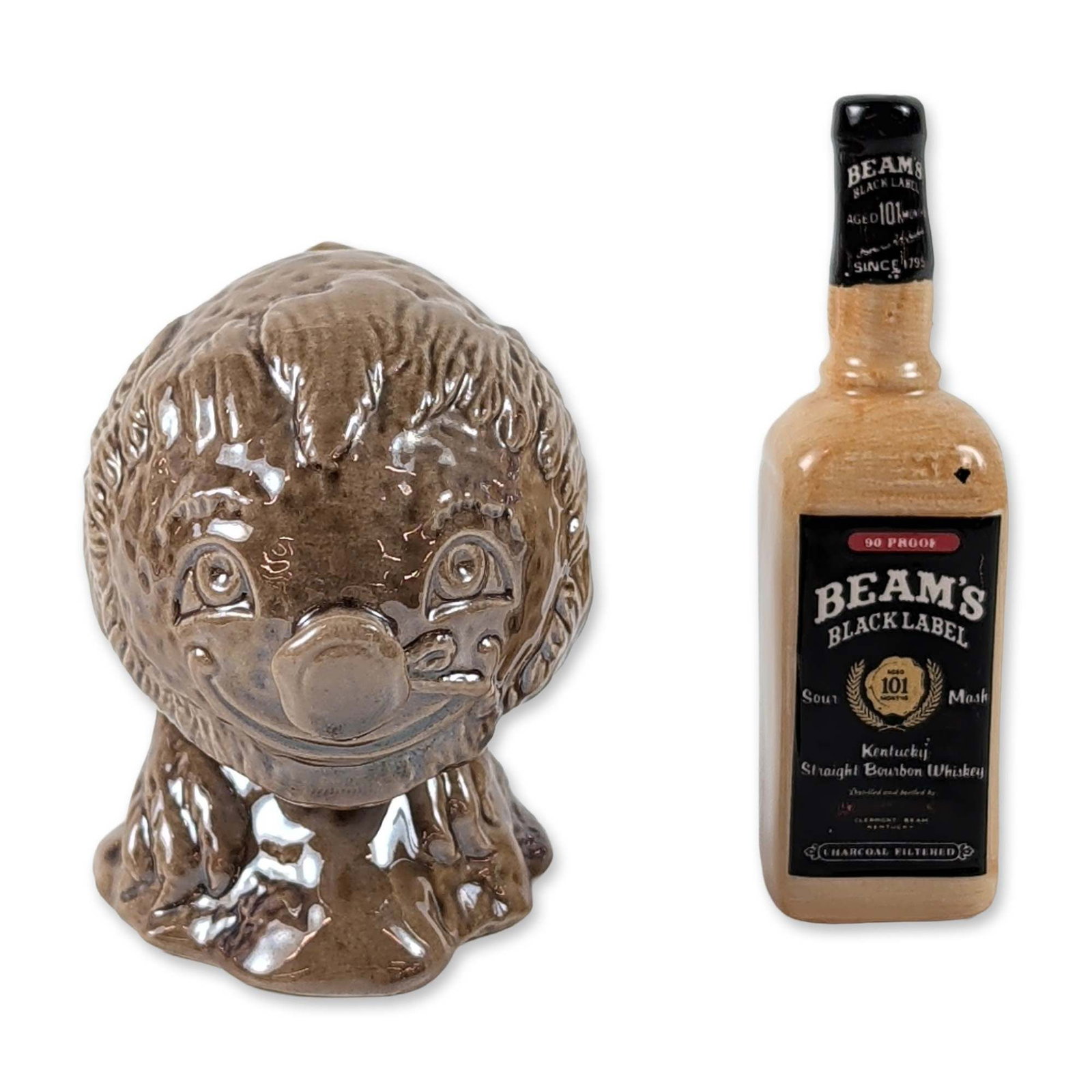 2pc Royal Doulton and Beswick Ceramic Miniature Decanter and Promotional Bottle: This pair of vintage miniature ceramics includes a liquor decanter and a promotional bottle from Royal Doulton and Beswick. The Royal Doulton piece is designed to resemble a Beam's Black Label bourbon