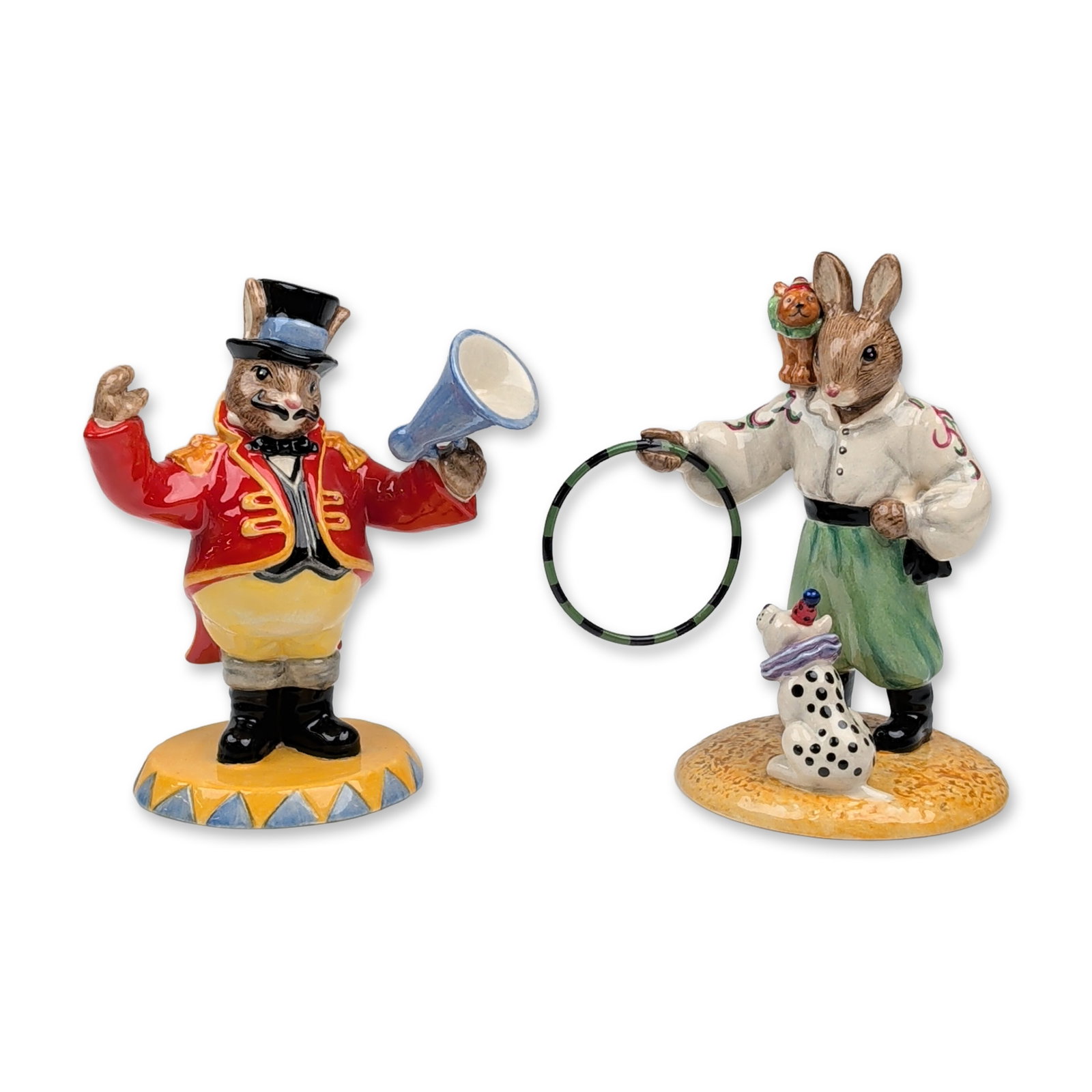 2pc Royal Doulton Porcelain Bunnykins Circus Figurines: Pair of Royal Doulton hand-decorated porcelain figurines from the Bunnykins circus series, featuring Randolph the Ringmaster and Tino the Trixstar. Randolph the Ringmaster (DB 330) was the 2005 Bunnyk
