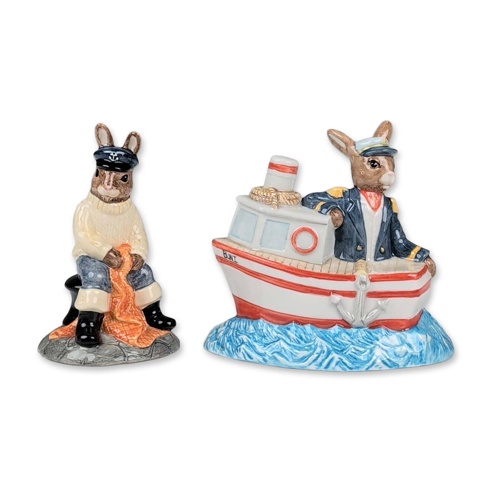 Two Royal Doulton Bunnykins Nautical Figurines: Royal Doulton. Two Bunnykins glazed ceramic figurines with nautical themes. The first, titled Ship Ahoy (DB 279), features an anthropomorphic rabbit captain in a red and white boat labeled BUNI set on
