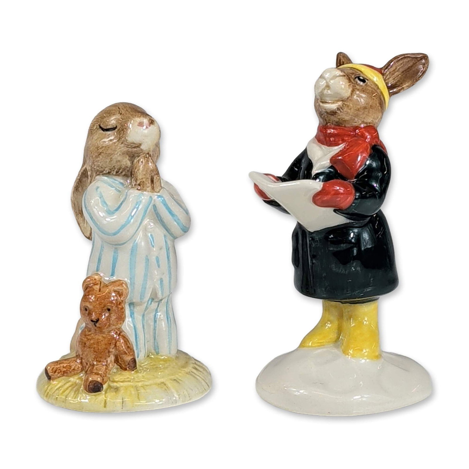 2pc Royal Doulton Bunnykins Carol Singer and Bedtime Figurines: Royal Doulton, England. Two Bunnykins series glazed ceramic figurines, both dated 1986. The lot features Carol Singer, model DB 104, designated as a special edition of 1,000 produced for U.K. Internat