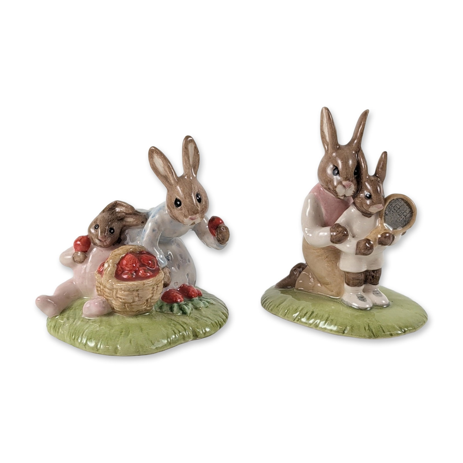 2pc Royal Doulton Bunnykins Ceramic Figurines: Royal Doulton porcelain figurines from the Bunnykins series. Set includes Tennis Bunnykins (DB 278) and Strawberries Bunnykins (DB 277), both featuring polychrome glazed decoration and anthropomorphic