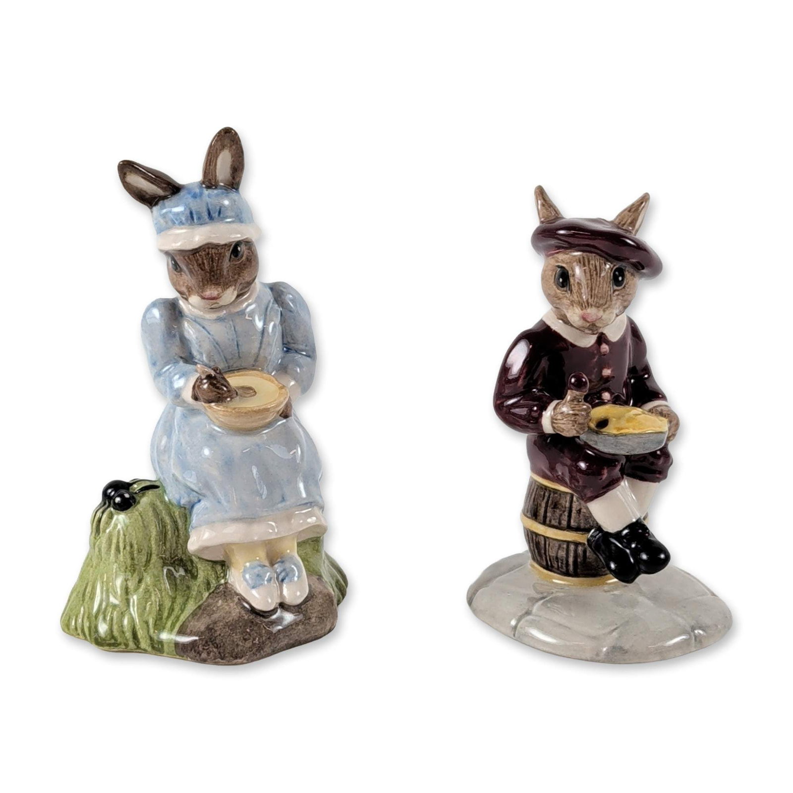 2pc Royal Doulton Bunnykins Figurines: Royal Doulton. Pair of glazed ceramic figurines from the Bunnykins Nursery Rhyme Collection. Little Jack Horner (DB 221) is depicted wearing a burgundy jacket and hat, standing beside a wooden barrel 
