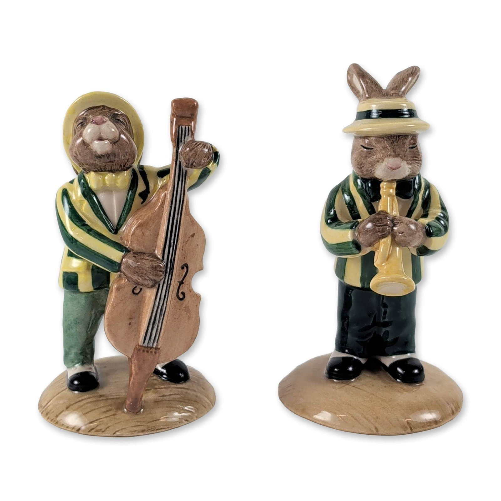 2pc Royal Doulton Bunnykins Jazz Band Figurines: Royal Doulton. Two glazed ceramic figurines from the Jazz Band Collection, comprising the Trumpet Player (DB 210) and the Double Bass Player (DB 185). Each rabbit is modeled in a boater hat and green 