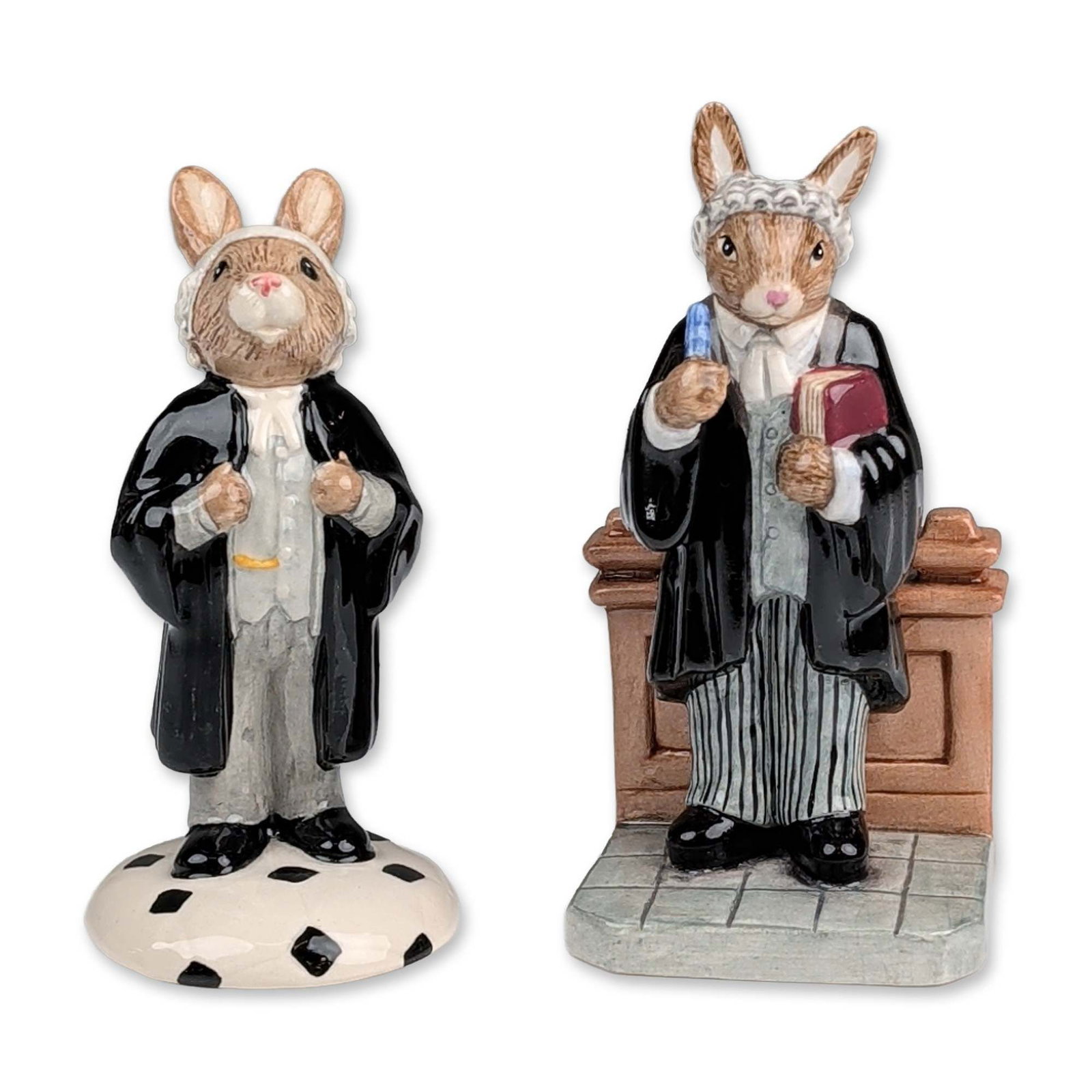 2pc Royal Doulton Legal Bunnykins Figurines: Royal Doulton, England. Two hand-decorated glossy ceramic figurines from the Bunnykins series, comprising Barrister DB 374 and Lawyer DB 214. The Barrister figure depicts a seated rabbit at a judicial