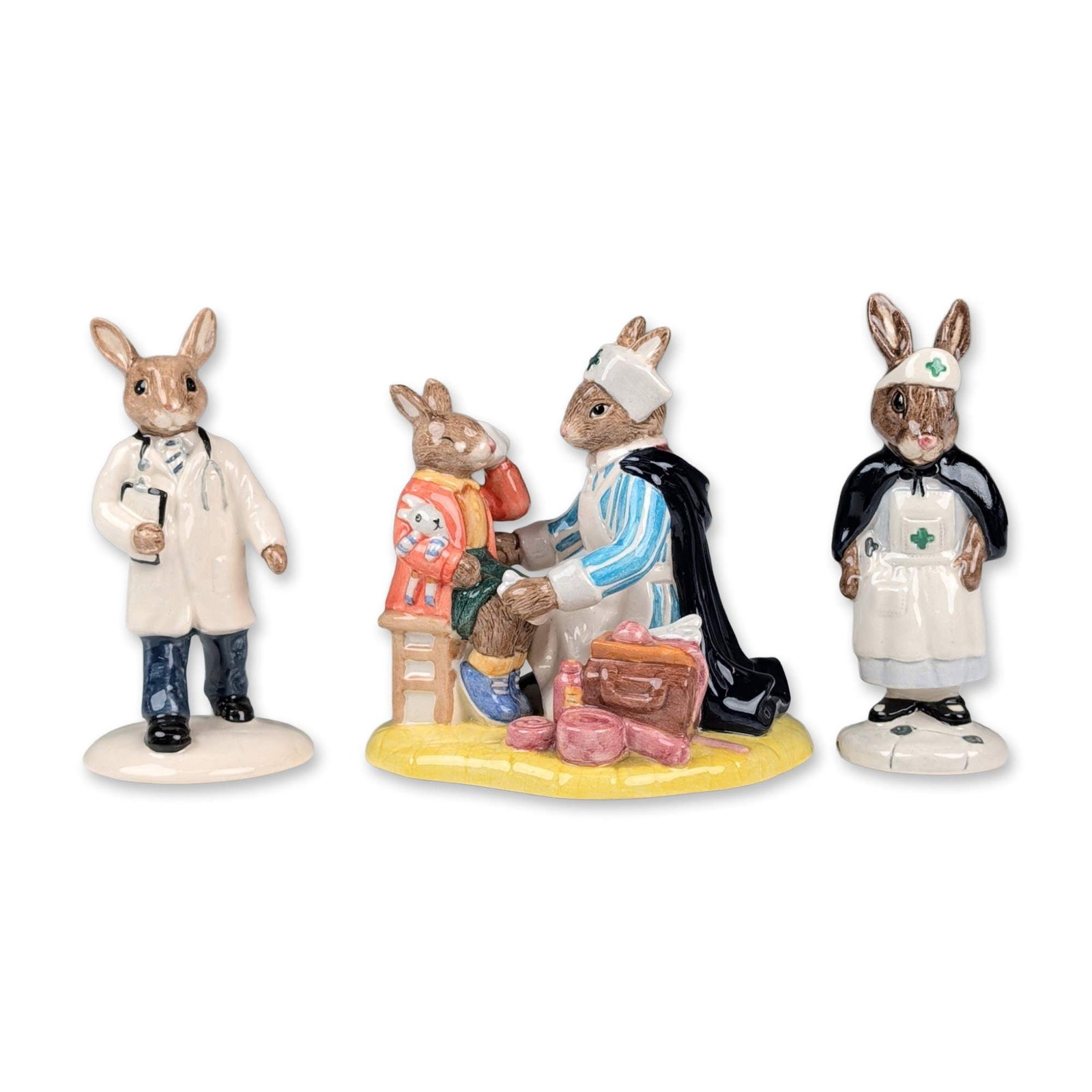 3pc Royal Doulton Bunnykins Figurines: Royal Doulton. Group of three glazed ceramic Bunnykins figurines with medical themes. Included are Nurse Bunnykins (DB 74) wearing a traditional nurse uniform with cape; Doctor Bunnykins (DB 181) dres