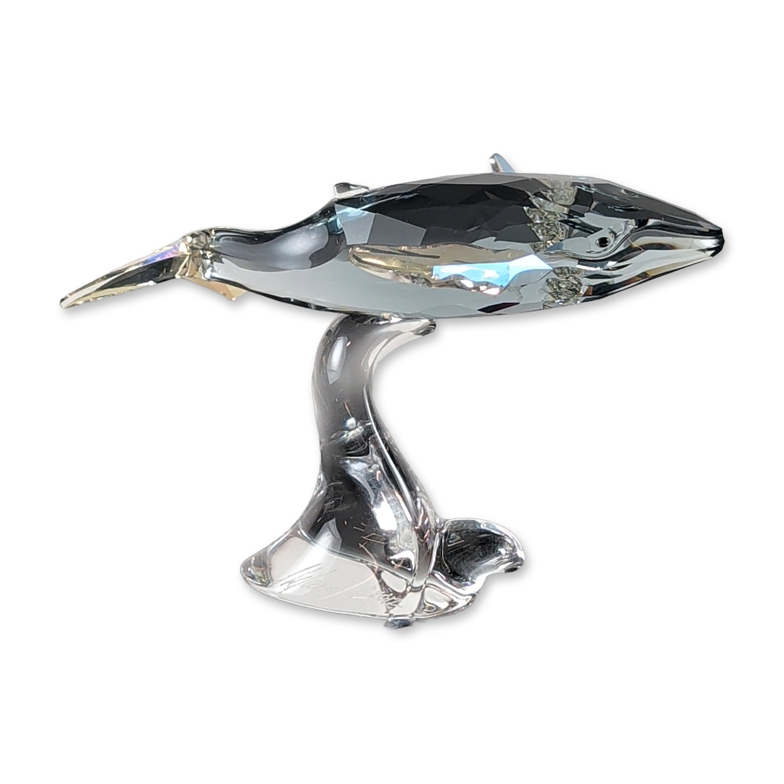 Swarovski Annual Edition Crystal Whale Figurine: The Swarovski SCS 2012 "Young Whale Calf" figurine (#1096747) is an expertly crafted collector's piece designed by Stefanie Nederegger. Created as the official companion to her 2012 Annual Edition Hum