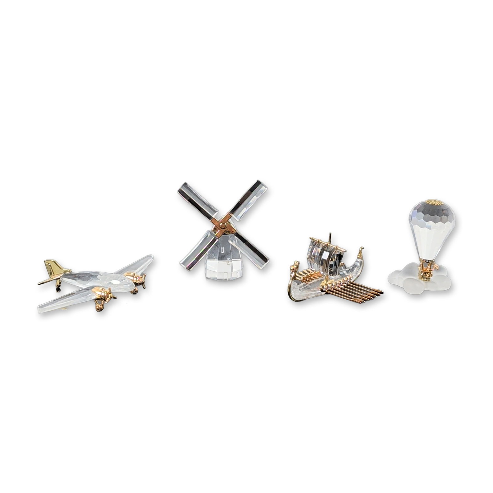 4pc Swarovski Crystal Memories Figurines: Swarovski, Crystal Memories Journeys series. Group of four miniature figurines in faceted lead crystal and gold-plated metal. The collection includes a hot air balloon with a frosted white cloud-form 