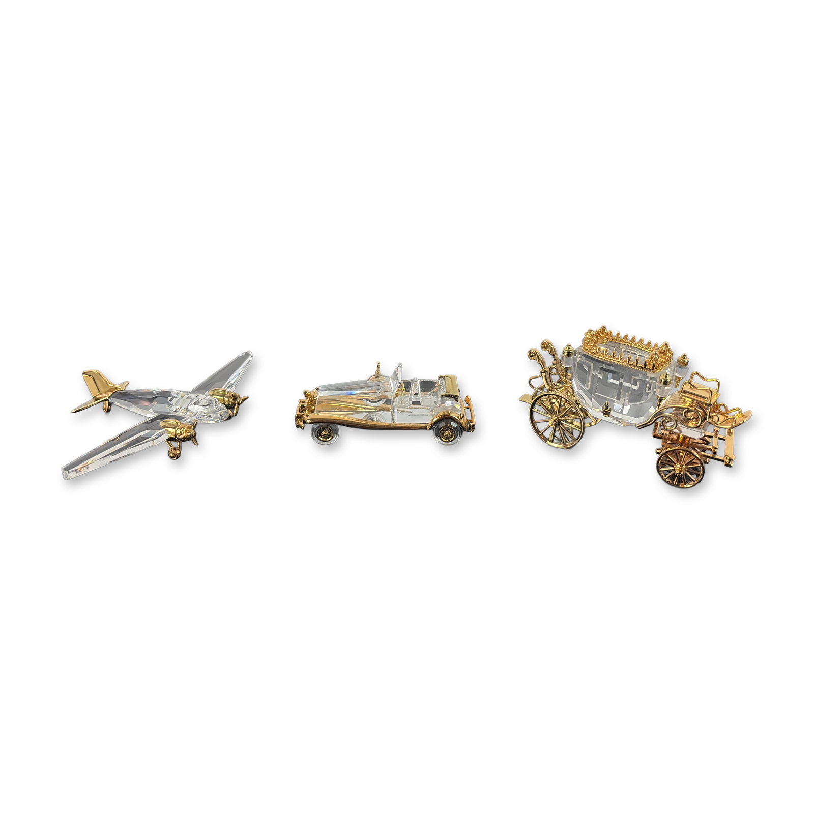 3pc Swarovski Austrian Crystal Memories Figurines: Swarovski, Austria. Three transport-themed miniature figurines from the Crystal Memories Journeys collection in faceted clear crystal with gold-plated metal accents. The collection includes a carriage