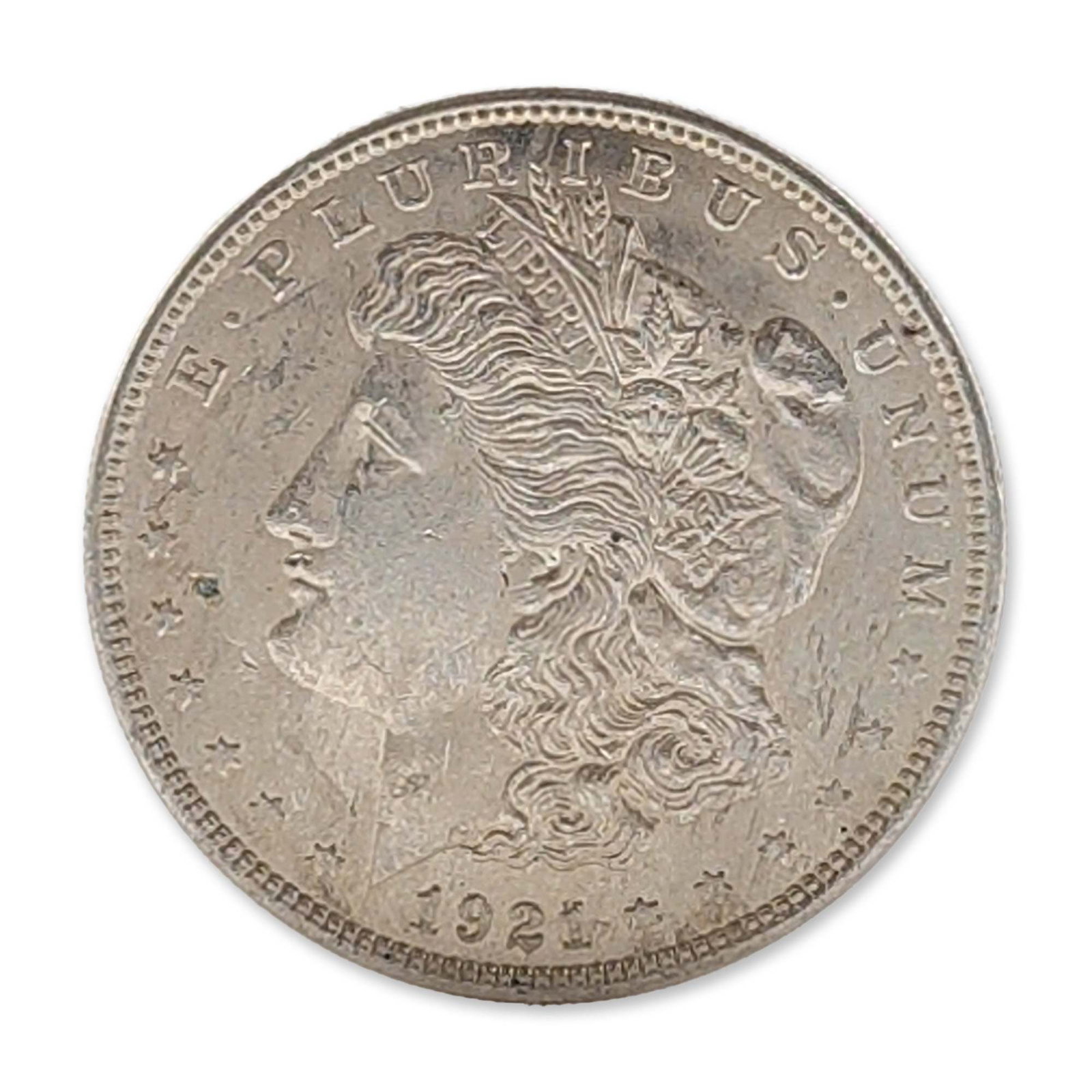 US 1921 Silver Morgan Dollar: US Philadelphia Mint, 1921. Morgan silver dollar in 90% silver and 10% copper, 0.900 fine. Features a profile of Liberty on the obverse and a heraldic eagle on the reverse. Reeded edge. Absence of min