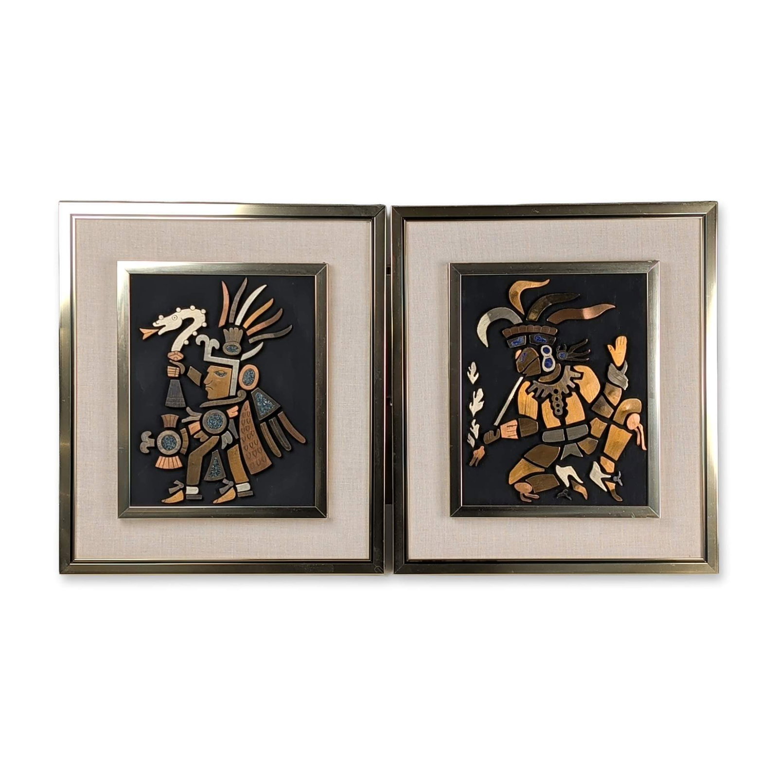 2pc Los Castillo Style Mexican Mixed-Metal Mesoamerican Warrior Wall Plaques: Mexican, mid-20th century. Pair of mixed-metal relief plaques featuring stylized Mesoamerican iconography. Each figure is constructed from layered and cut copper, brass, and white metal with crushed s