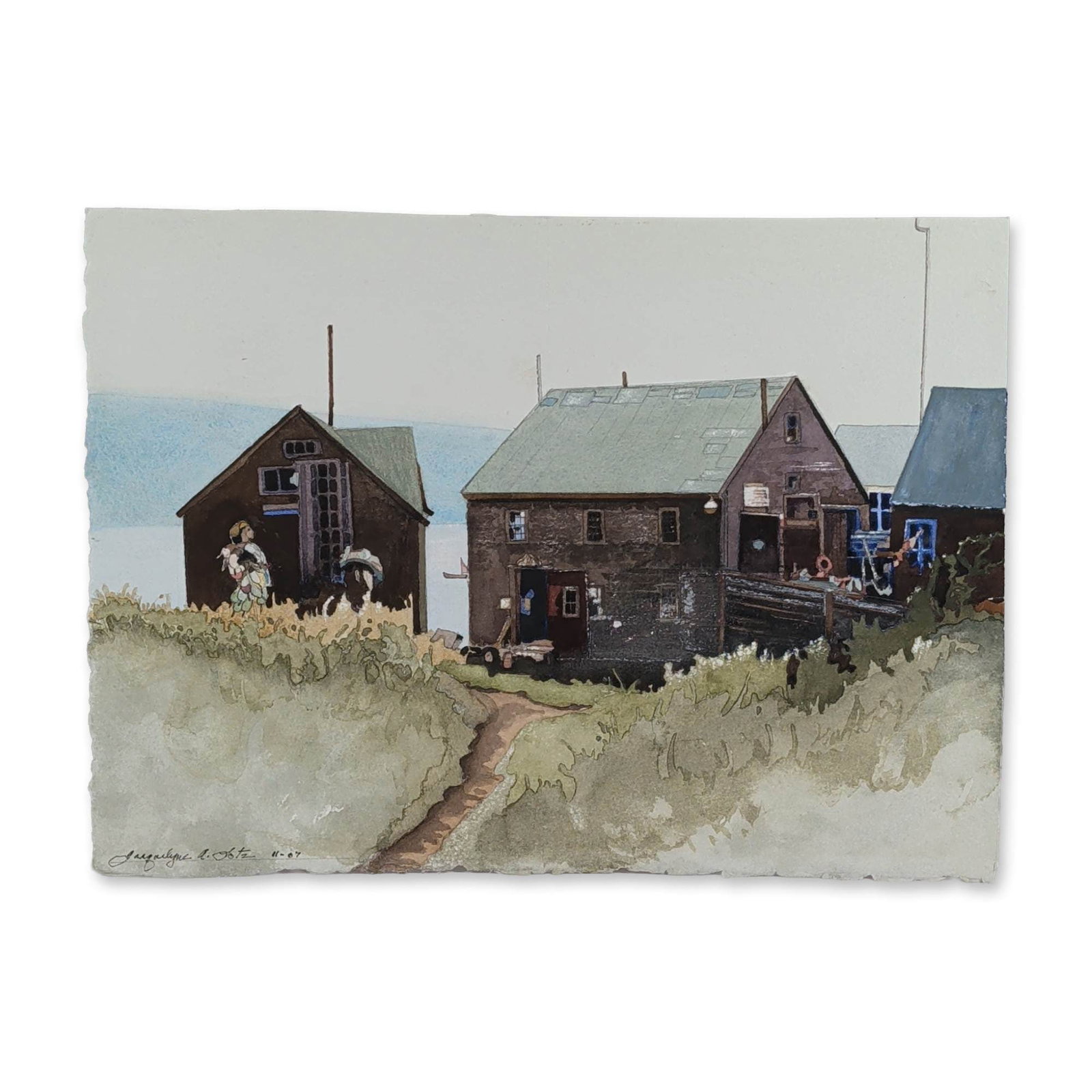 Jacquelyne A. Lotz (American, b. 1935) Original Watercolor on Paper, Signed: Coastal landscape scene, watercolor and ink on heavy, textured, deckled-edge paper. The composition depicts rustic wooden cottages or fishing shacks situated on a grassy hill overlooking the water,