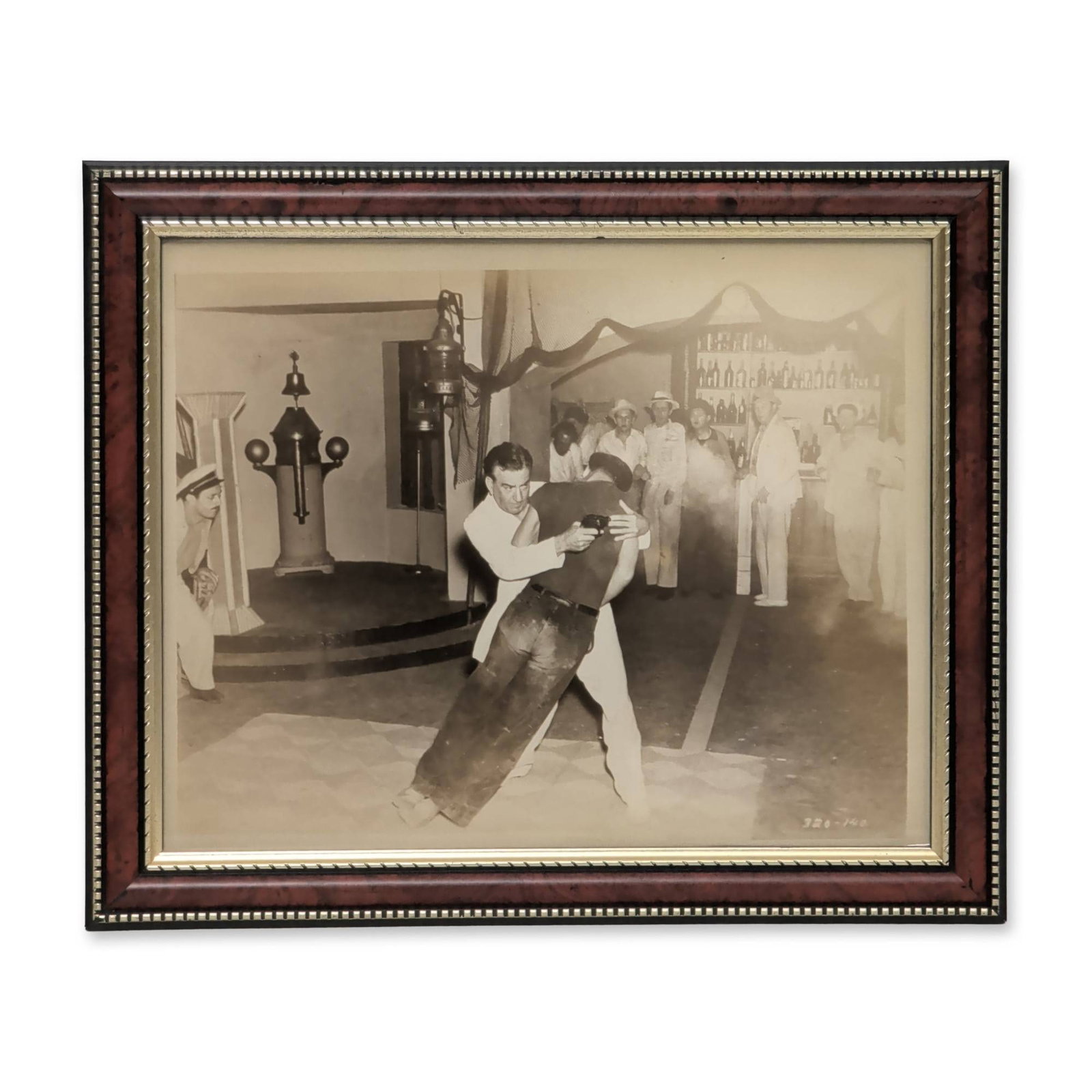 Cinematic Silver Gelatin Production Still of Actor John Litel: Silver gelatin print depicting a dramatic cinematic production scene featuring actor John Litel. The composition features a physical struggle between two men in an interior setting, with Litel in a