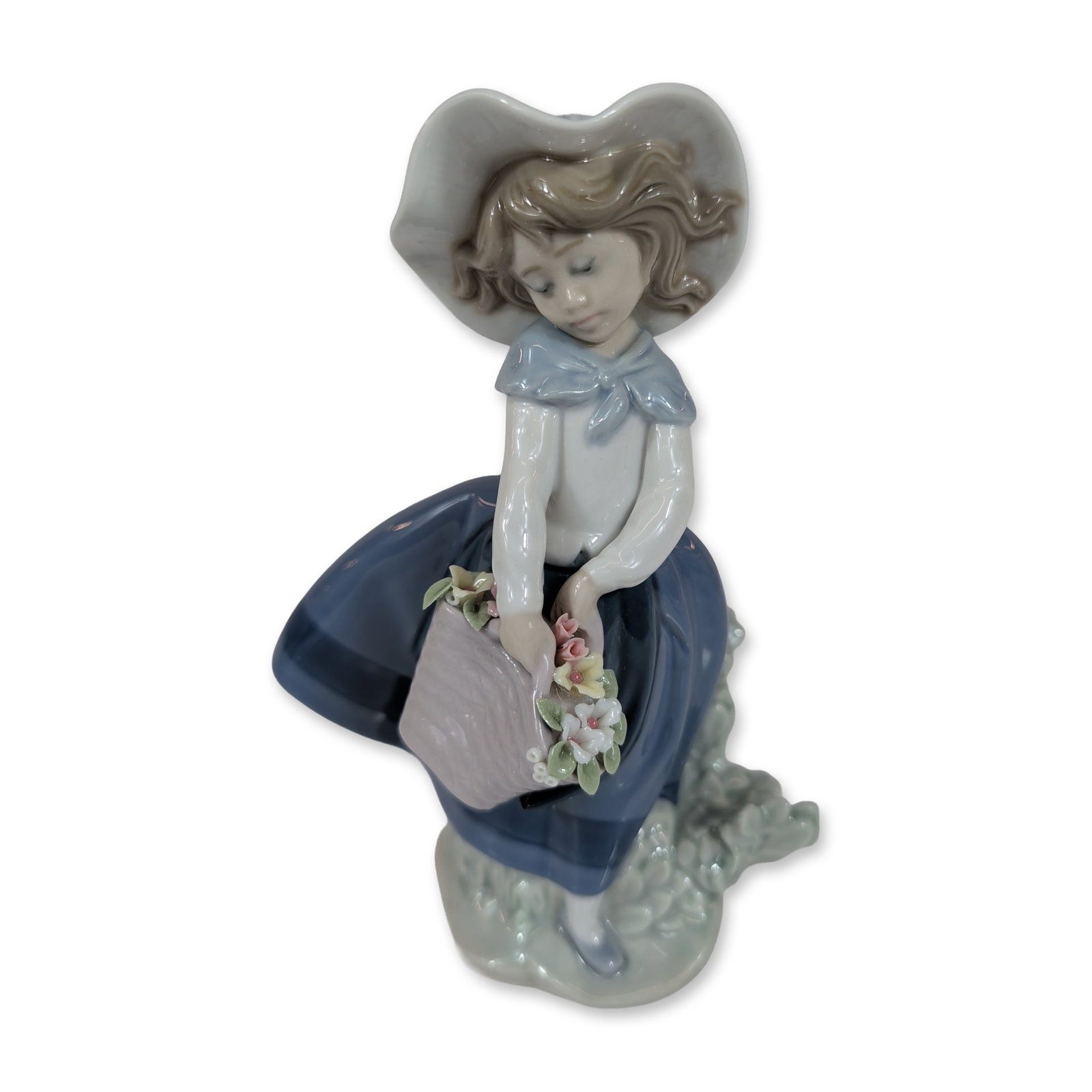 Lladro Pretty Pickings Figurine 5222: Model number 5222, designed by sculptor Jose Puche. The figure depicts a young girl in a wide-brimmed hat and blue skirt leaning over a woven basket containing an assortment of delicate pastel-colored