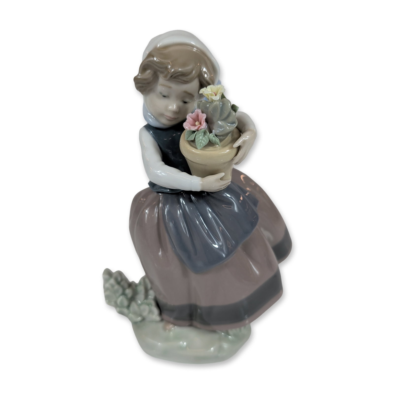 Lladro Spring is Here Porcelain Figurine 5223: Lladro Spanish glazed porcelain figurine titled Spring is Here, model number 5223, designed by sculptor Jose Puche. The figure depicts a young girl wearing a bonnet and apron holding a flower pot with