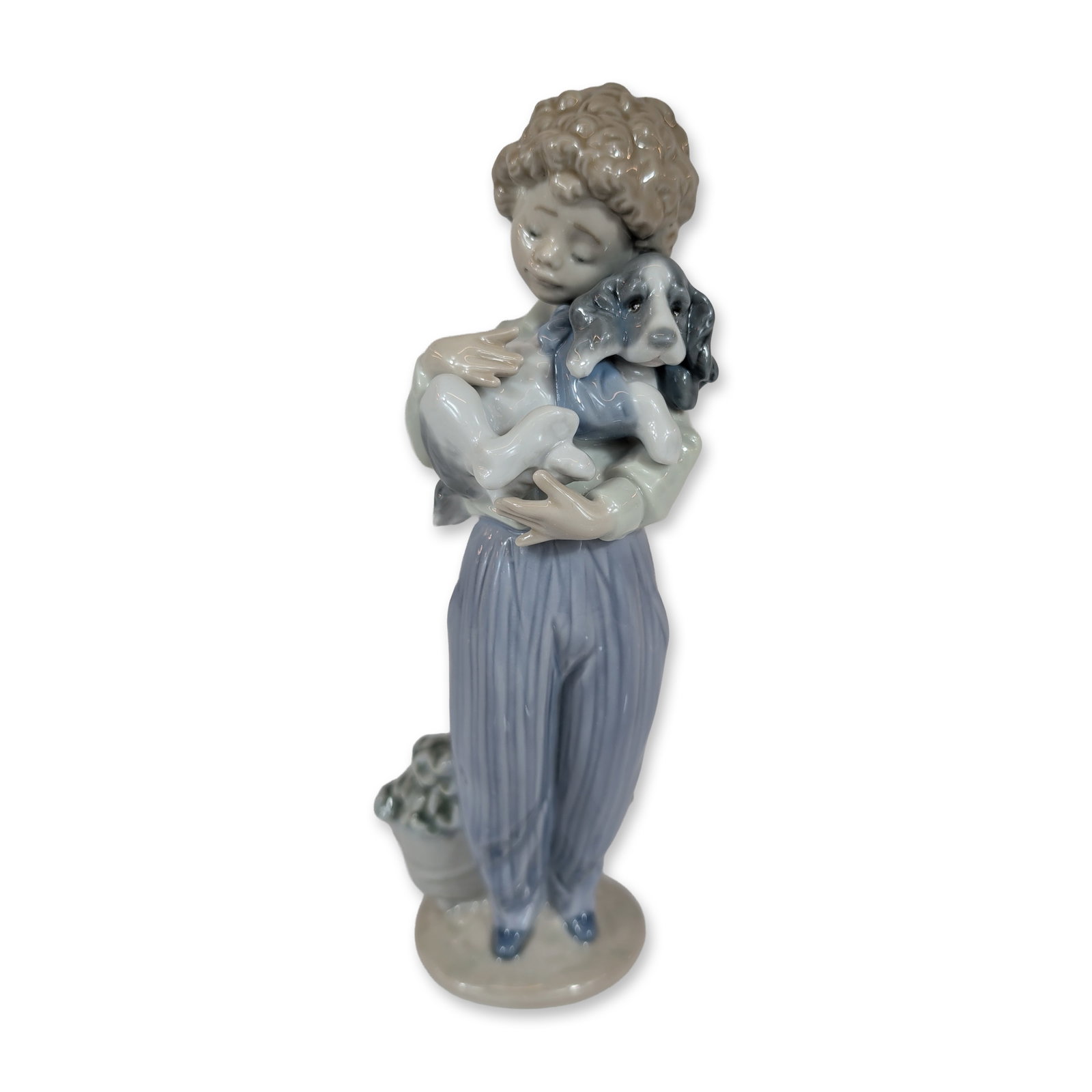 Lladro My Buddy Porcelain Figurine: Lladro Spanish glazed porcelain figurine titled My Buddy, model number 7609. The standing figure depicts a boy in pastel tones cradling a puppy, with a basket of high-relief flowers at his feet. Marke