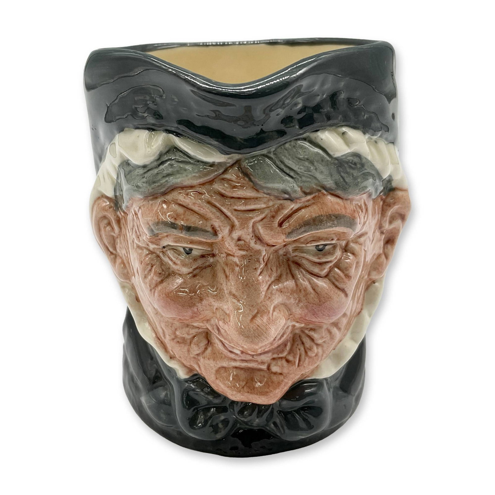 Granny D6384 - Small - Royal Doulton Character Jug: Style One, Toothless Granny. Dark green and white coloration. Royal Doulton backstamp. Artist: Harry Fenton Dimensions: 3.25"H Date or Era: 1935 Manufacturer or Brand: Royal Doulton Country of Ori