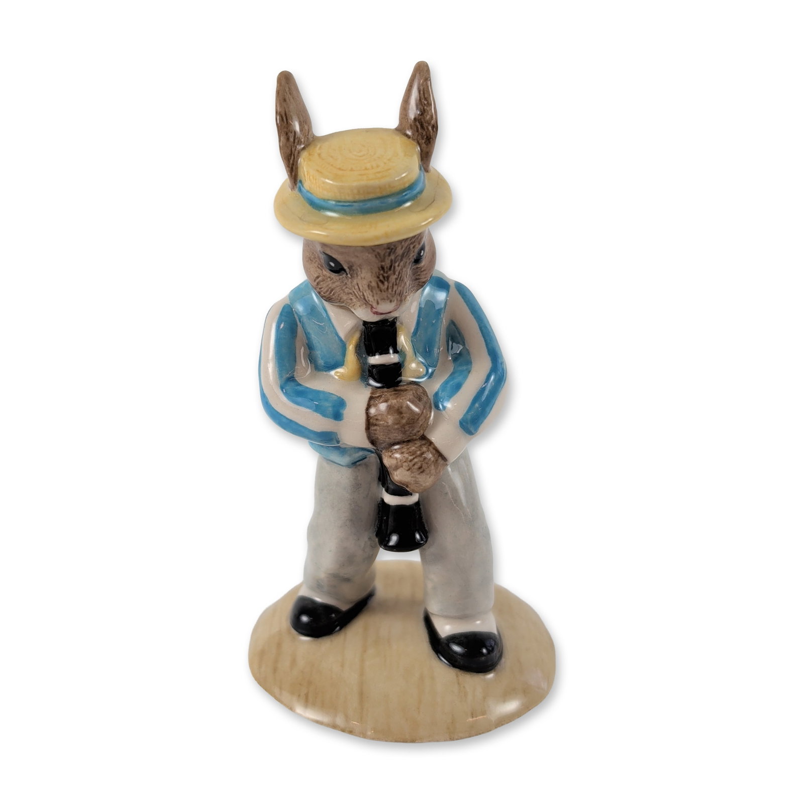 Royal Doulton Bunnykins Clarinet Player Figurine: Royal Doulton glazed porcelain Bunnykins figurine titled Clarinet Player from the Jazz Band Collection, model DB 184. The rabbit figure is dressed in a blue and white striped blazer, grey trousers, an
