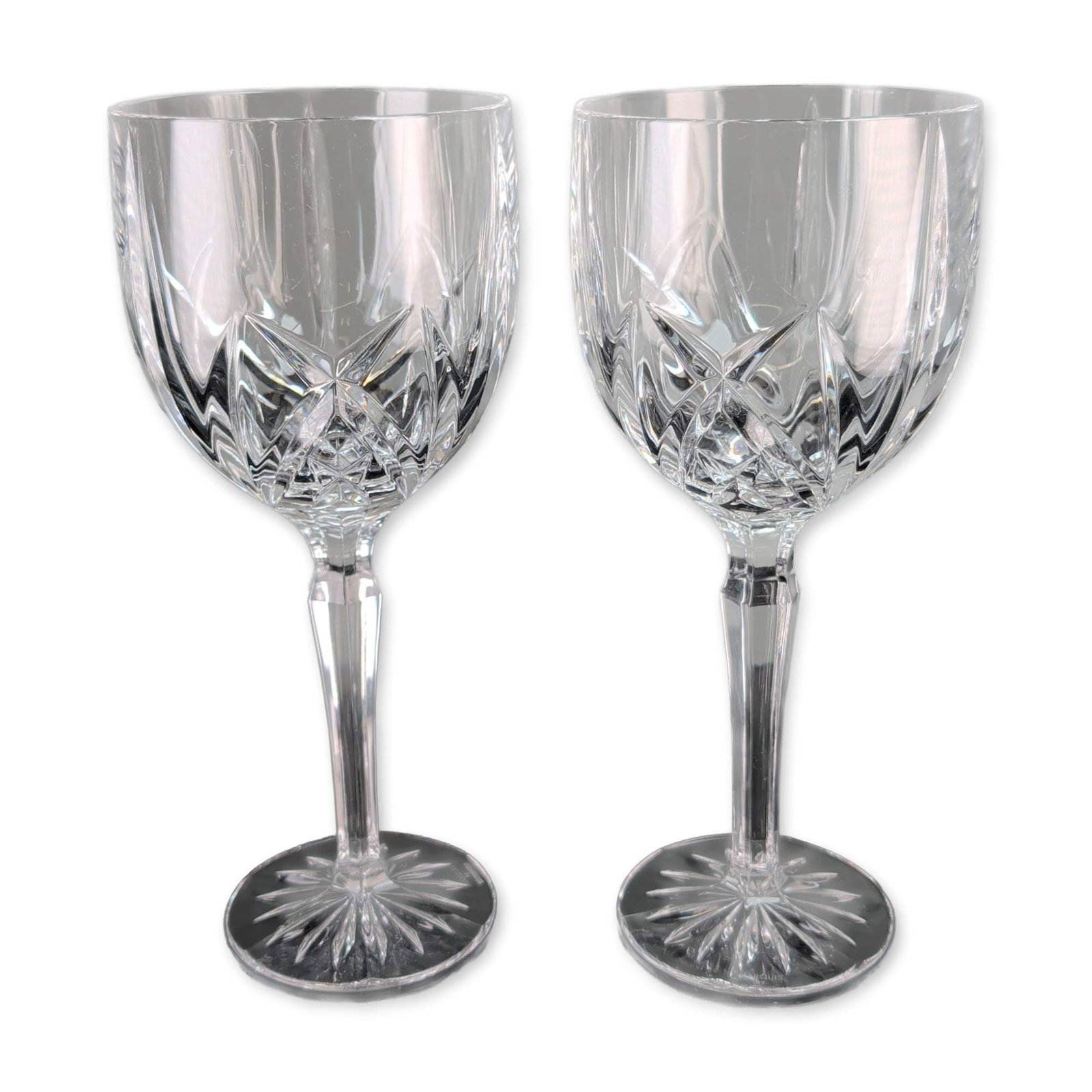 Pair of Marquis by Waterford Brookside Crystal Water Goblets: Marquis by Waterford. Pair of water goblets in crystal, featuring the Brookside pattern with deep crisscross diamond and vertical wedge cuts. Faceted hexagonal stems terminate in circular feet with ra