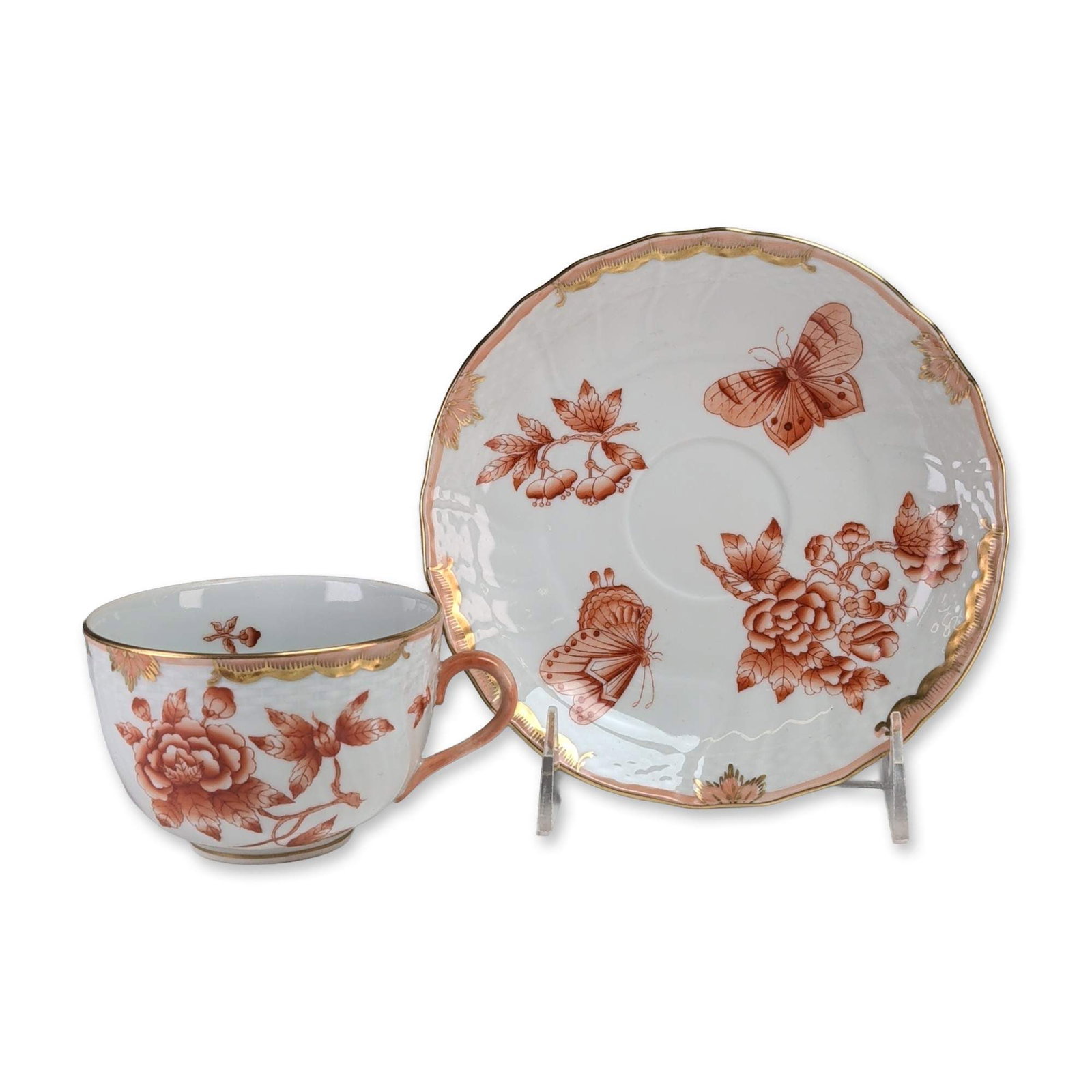 Herend Fortuna Rust Porcelain Cup and Saucer: Herend Porcelain Manufactory, Hungary. Cup and saucer set in the Fortuna Rust pattern, crafted in hand-painted porcelain with iron-red overglaze enamel. The decoration features stylized floral sprays 