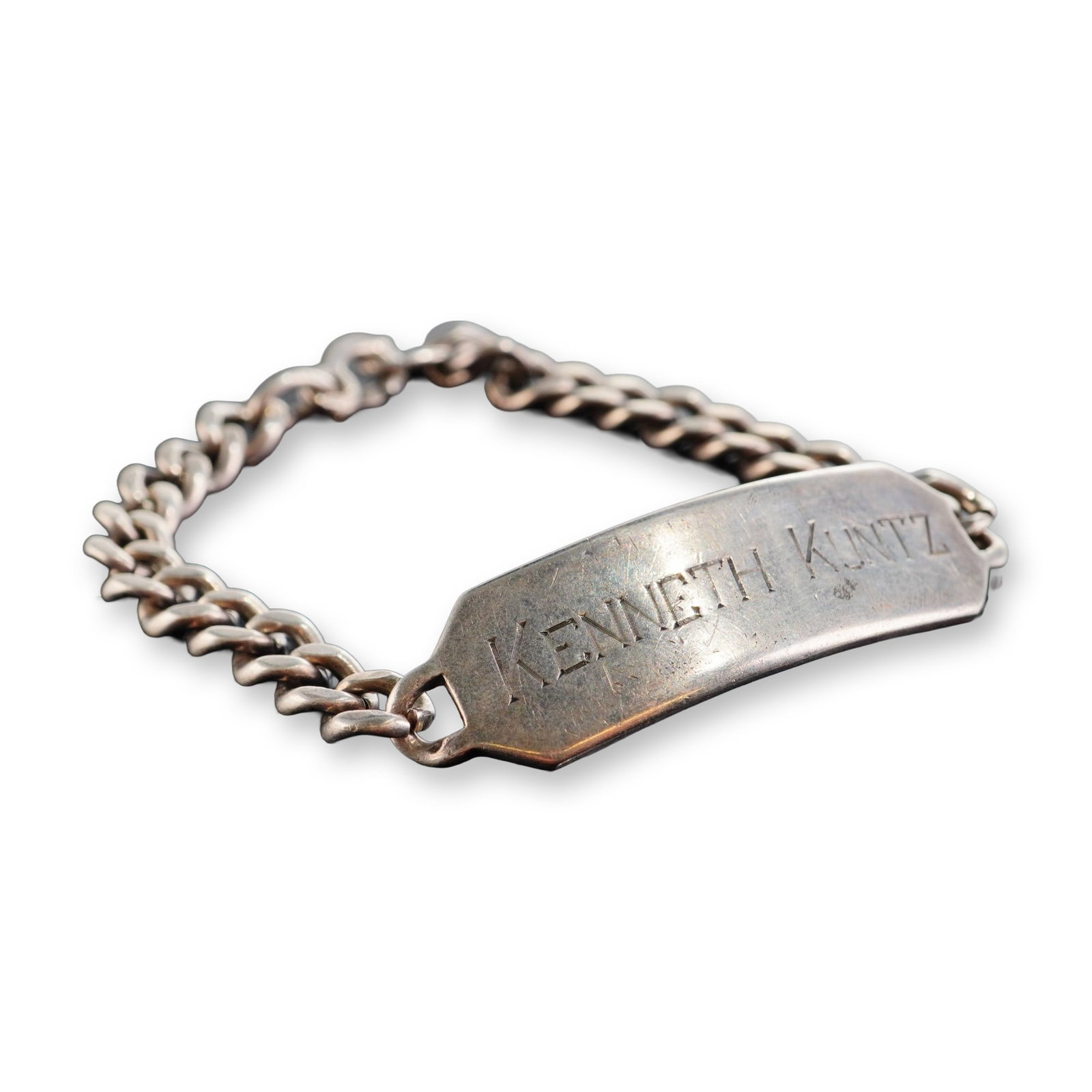 Vintage WWII Style Sterling Silver ID Bracelet: Mid-20th century American military style identification bracelet in sterling silver, featuring a rectangular ID plate and a heavy curb link chain. The plate is engraved with the name KENNETH KUNTZ in 