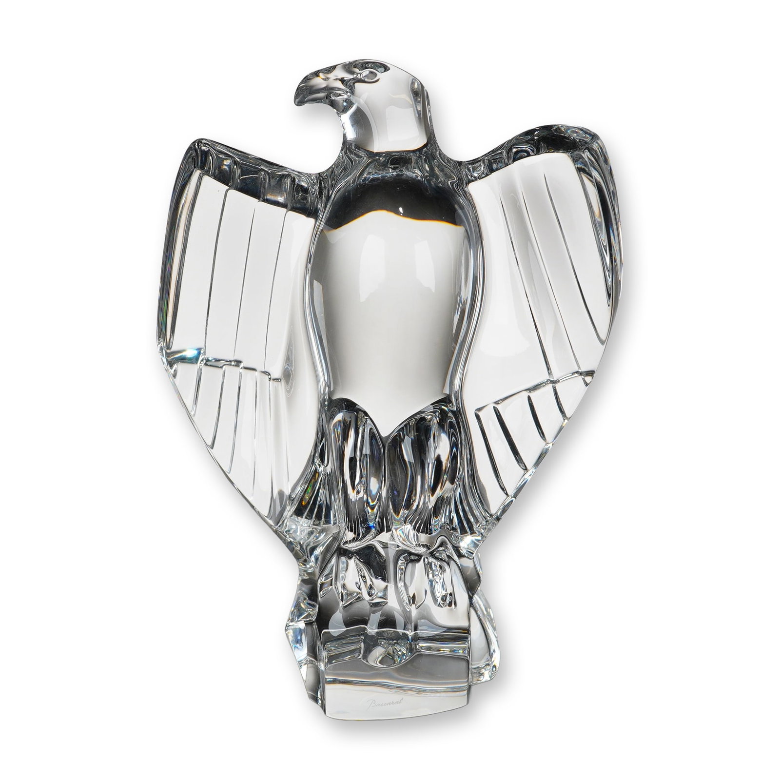 Baccarat Crystal American Eagle Sculpture: Eagle sculpture in clear lead crystal, depicting an American eagle with partially outspread wings in a stylized modernistic form. The bird is perched upon a faceted, rock-like base and features polish