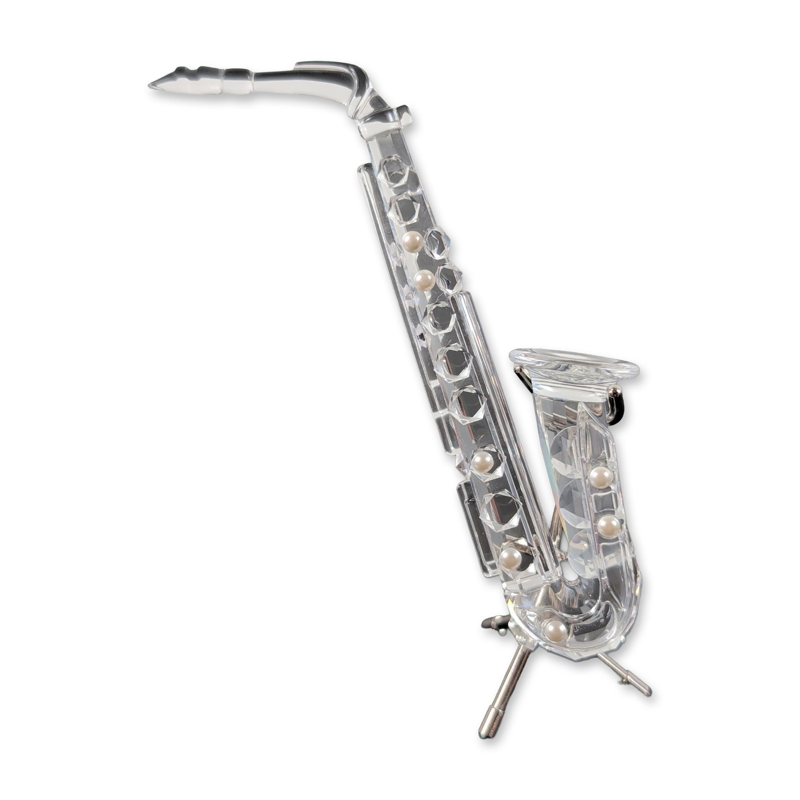 Swarovski Silver Crystal Saxophone Figurine: Swarovski Silver Crystal faceted lead crystal saxophone figurine, part of the Musical Instruments series. The figure features a faceted clear crystal body with inset faux pearl key accents and a chrom
