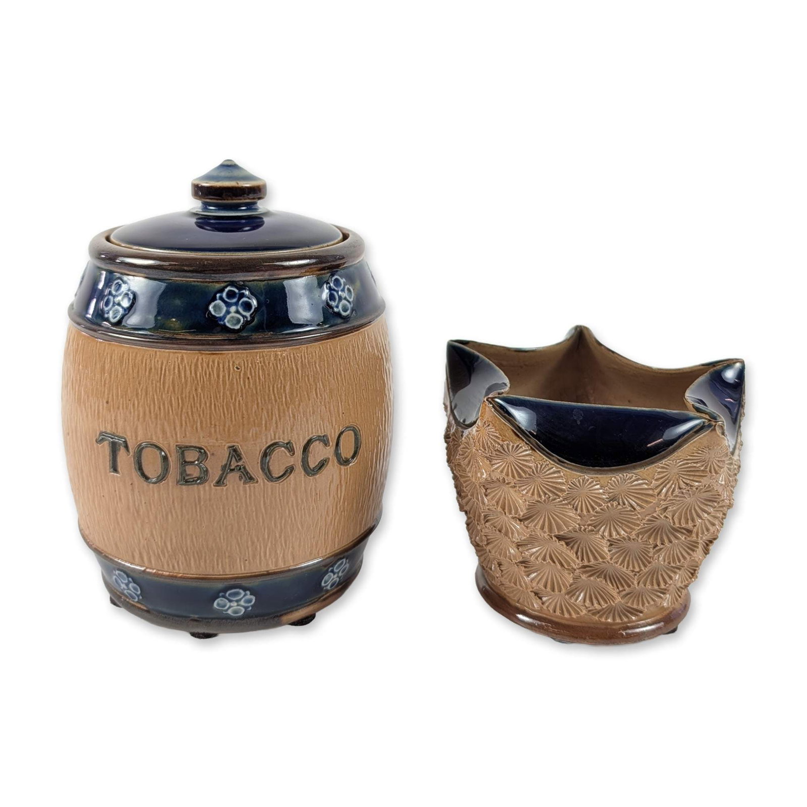 2pc Royal Doulton Lambeth Stoneware Tobacco Jar and Match Striker: Royal Doulton Lambeth, England, late 19th to early 20th century. Tobacco jar and Match Striker vessel in salt-glazed and Silicon stoneware. The barrel-form jar features an incised wood-grain texture, 